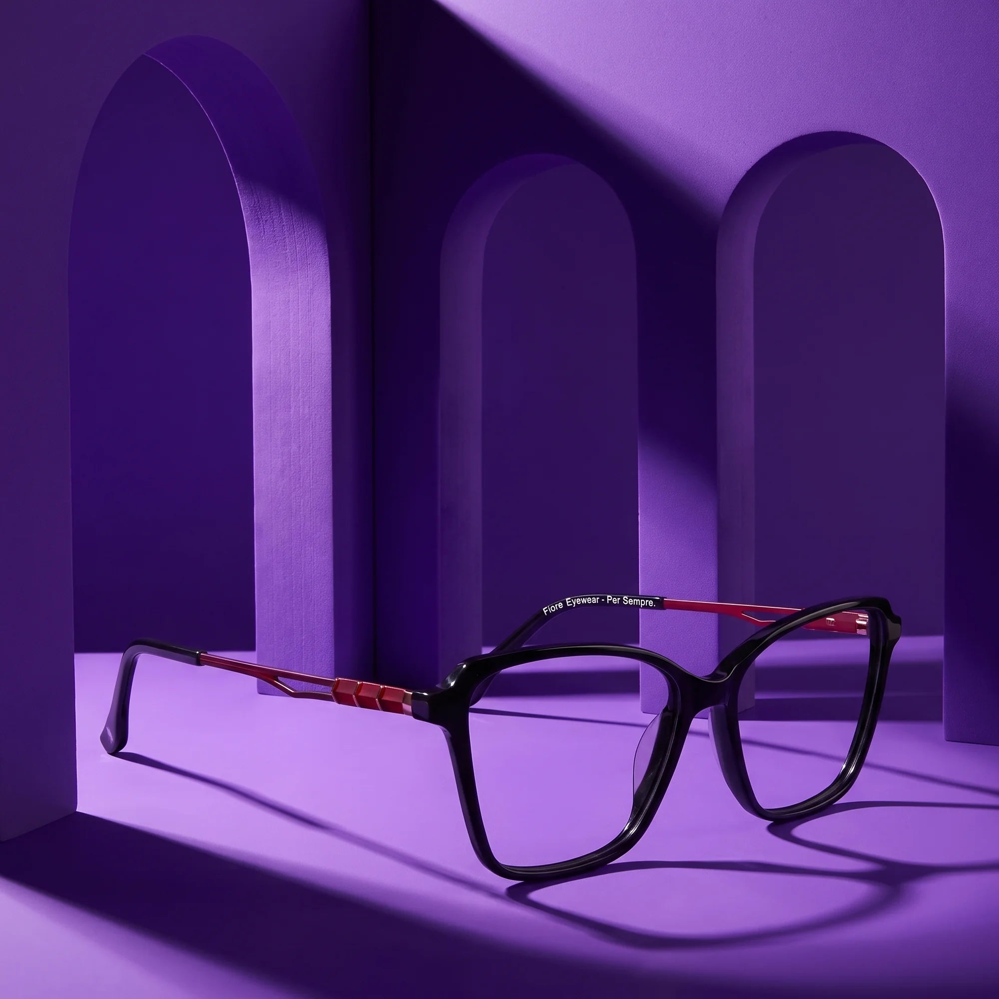 Fiore 1006 eyeglasses in black – staged on a sculptural violet architecture set