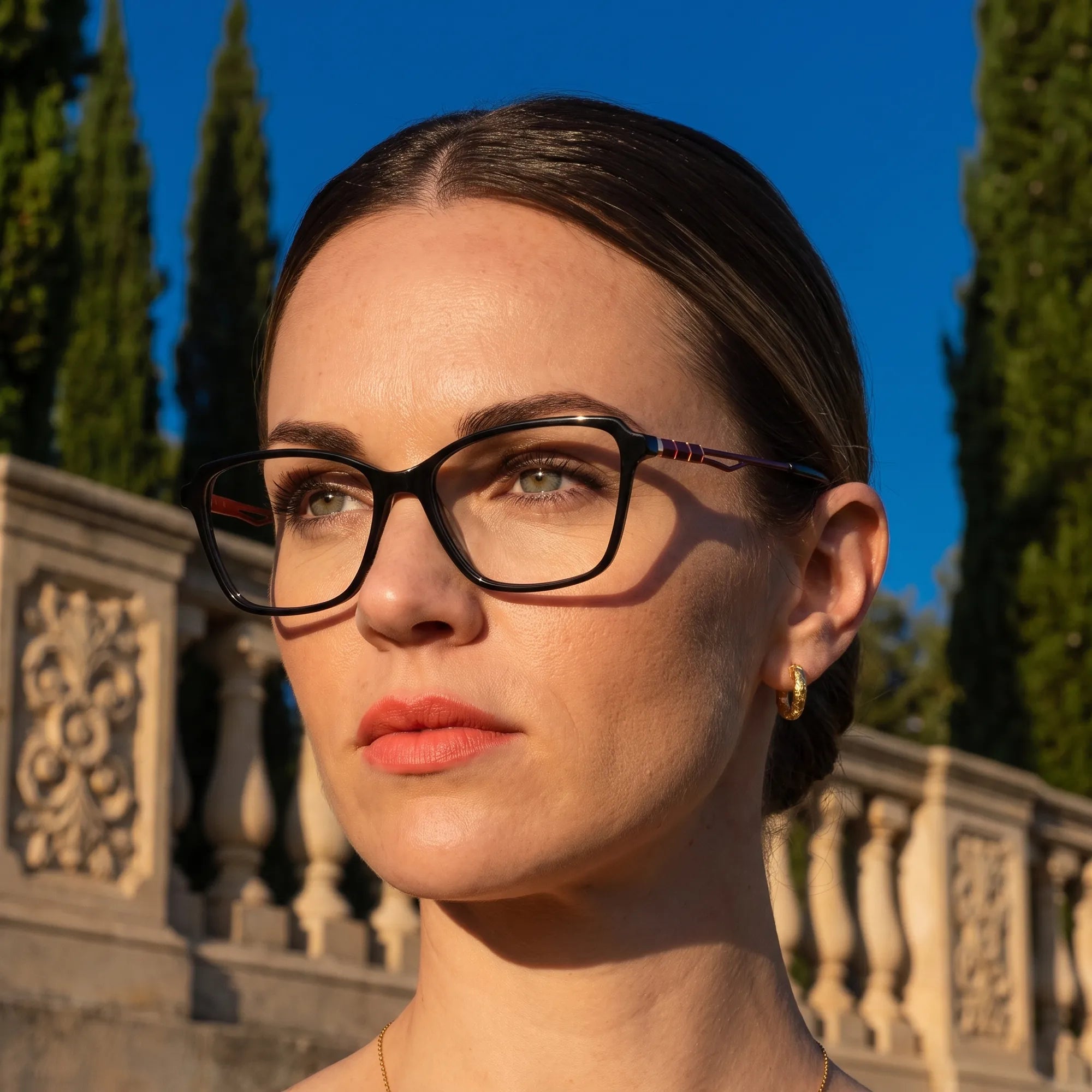 Fiore 1006 eyeglasses in black, worn by a model – campaign portrait, golden-hour Italian villa terrace