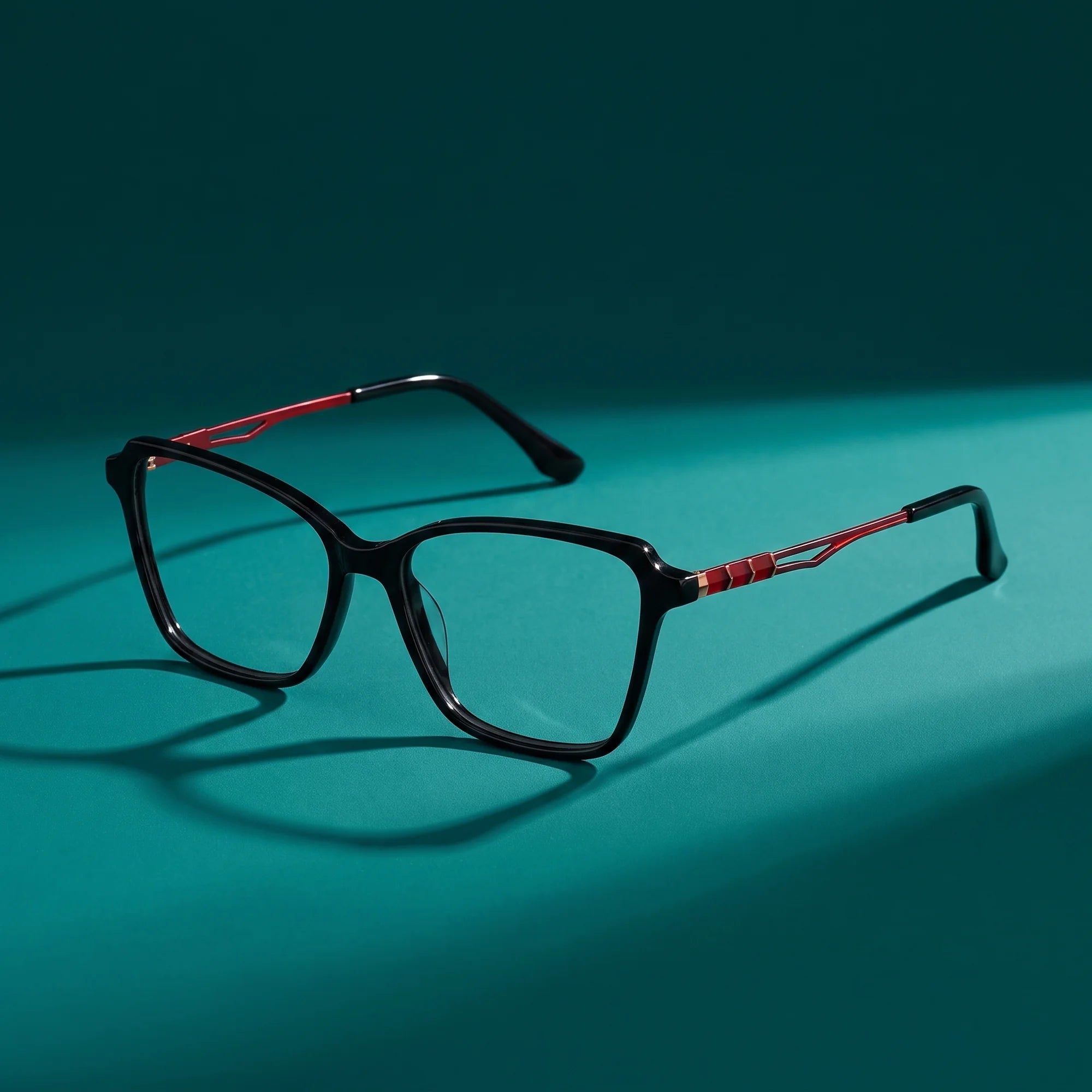 Fiore 1006 eyeglasses in black – hero still life against a deep teal backdrop