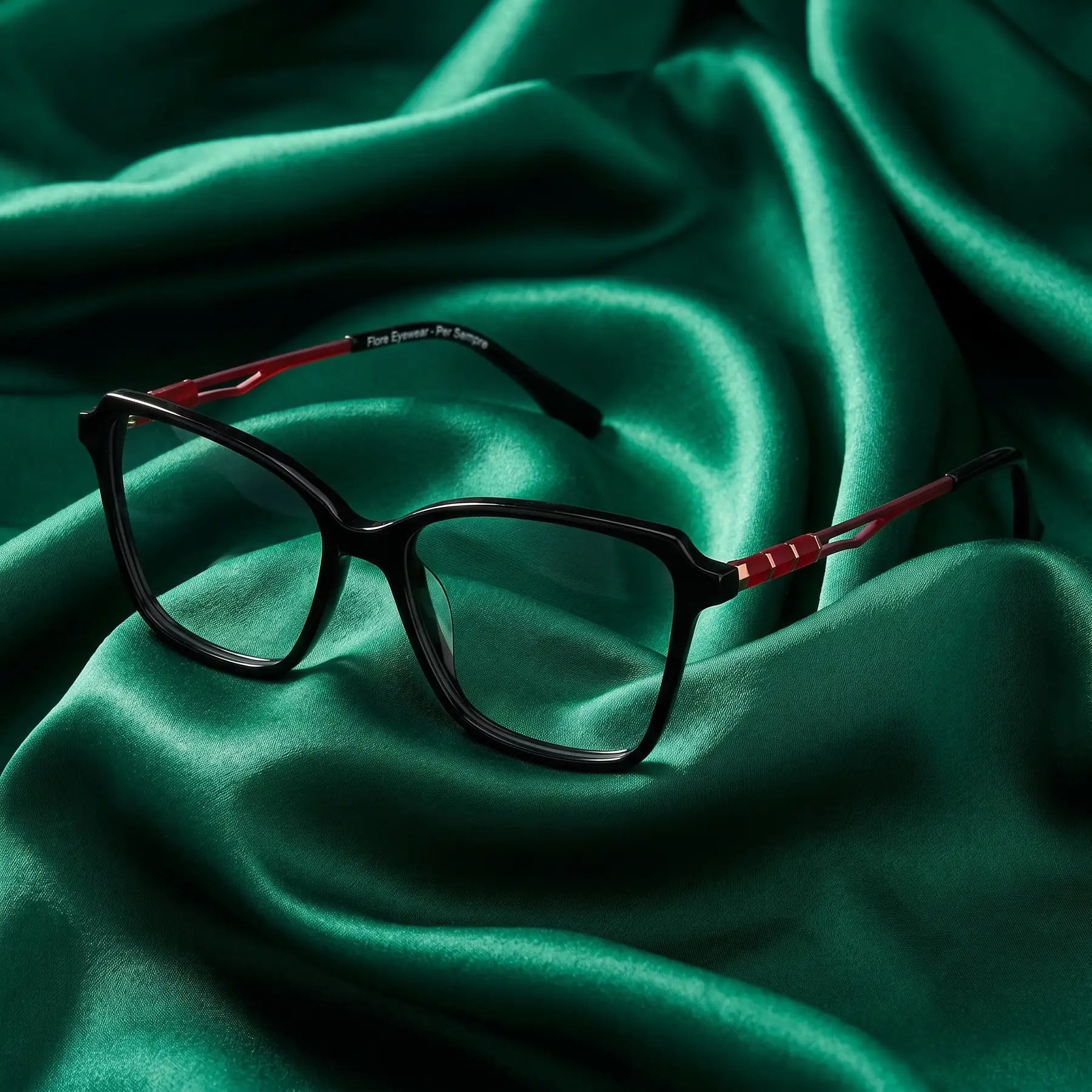 Fiore 1006 eyeglasses in black – nested in flowing emerald silk