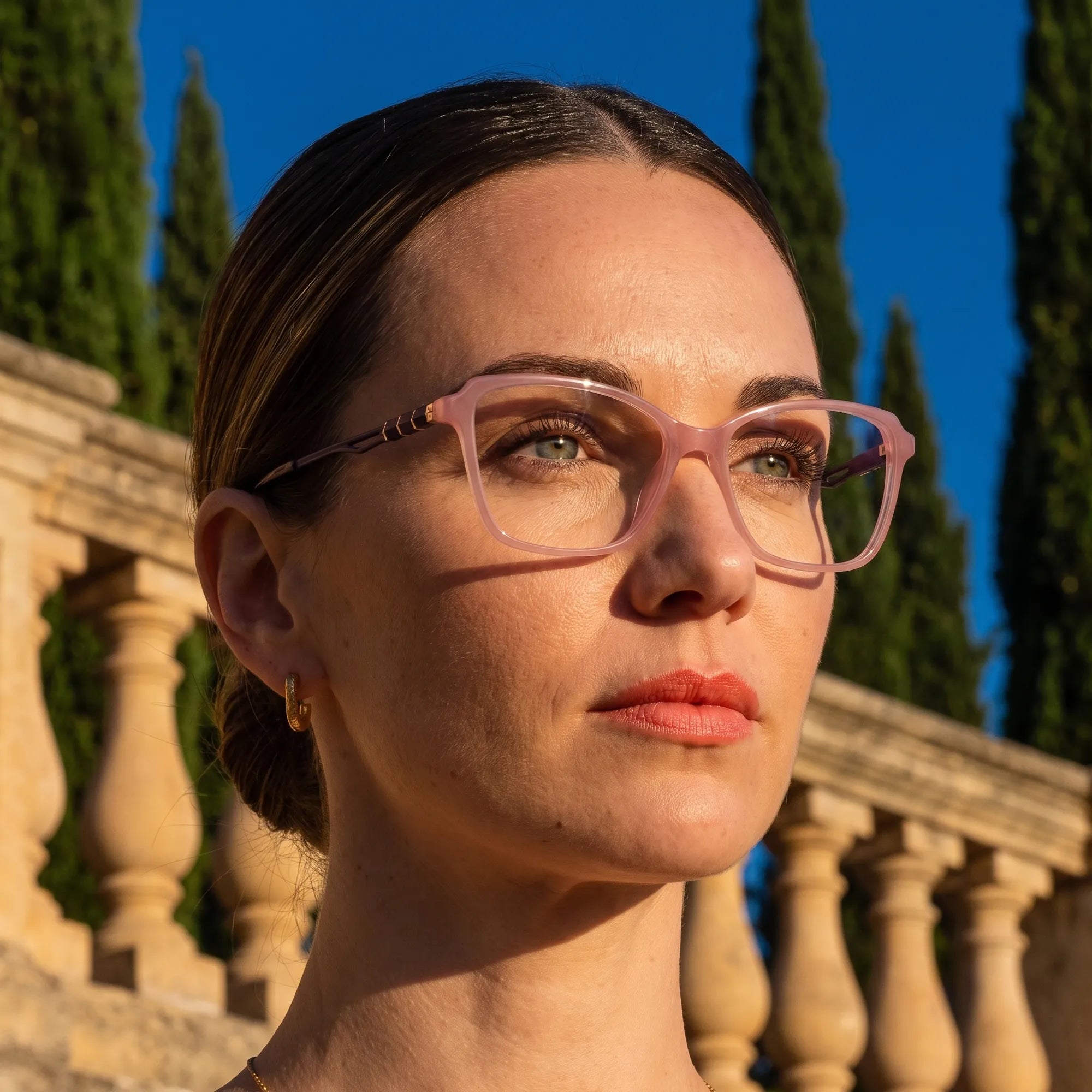 Fiore 1006 eyeglasses in pink, worn by a model – campaign portrait, golden-hour Italian villa terrace