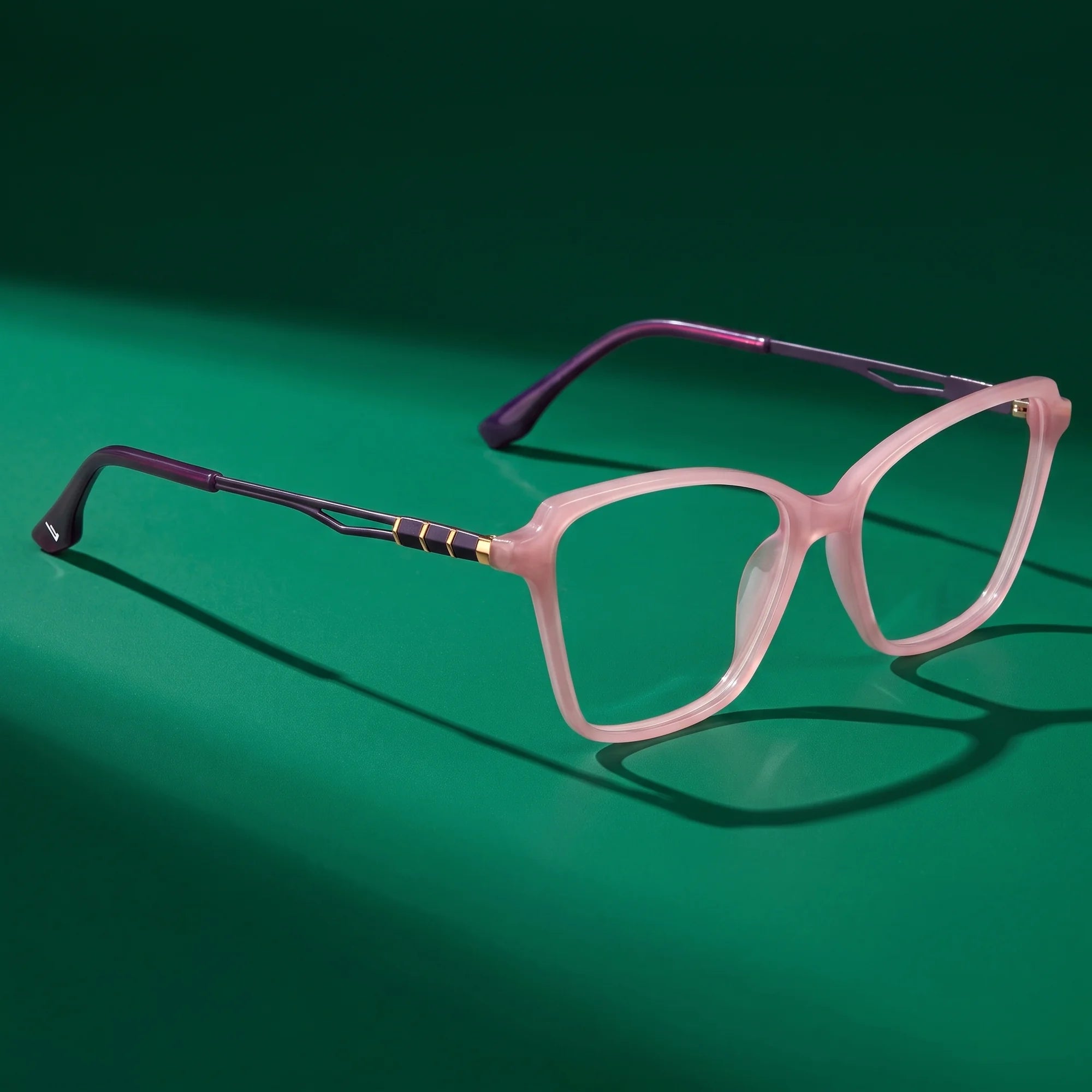 Fiore 1006 eyeglasses in pink – editorial still life on a saturated emerald set