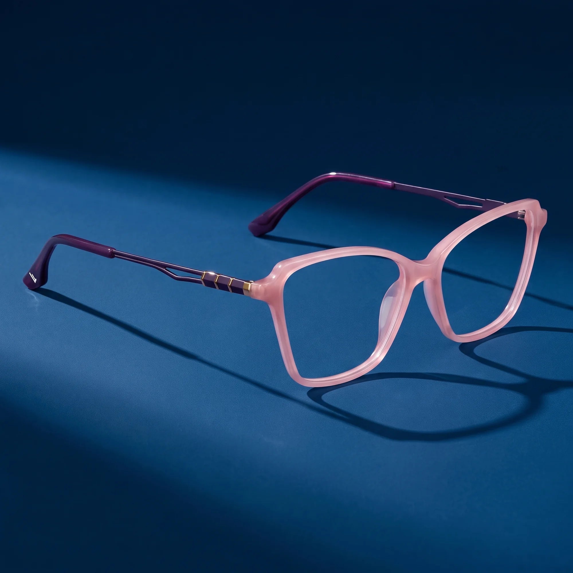 Fiore 1006 eyeglasses in pink – still life on a seamless midnight blue studio backdrop