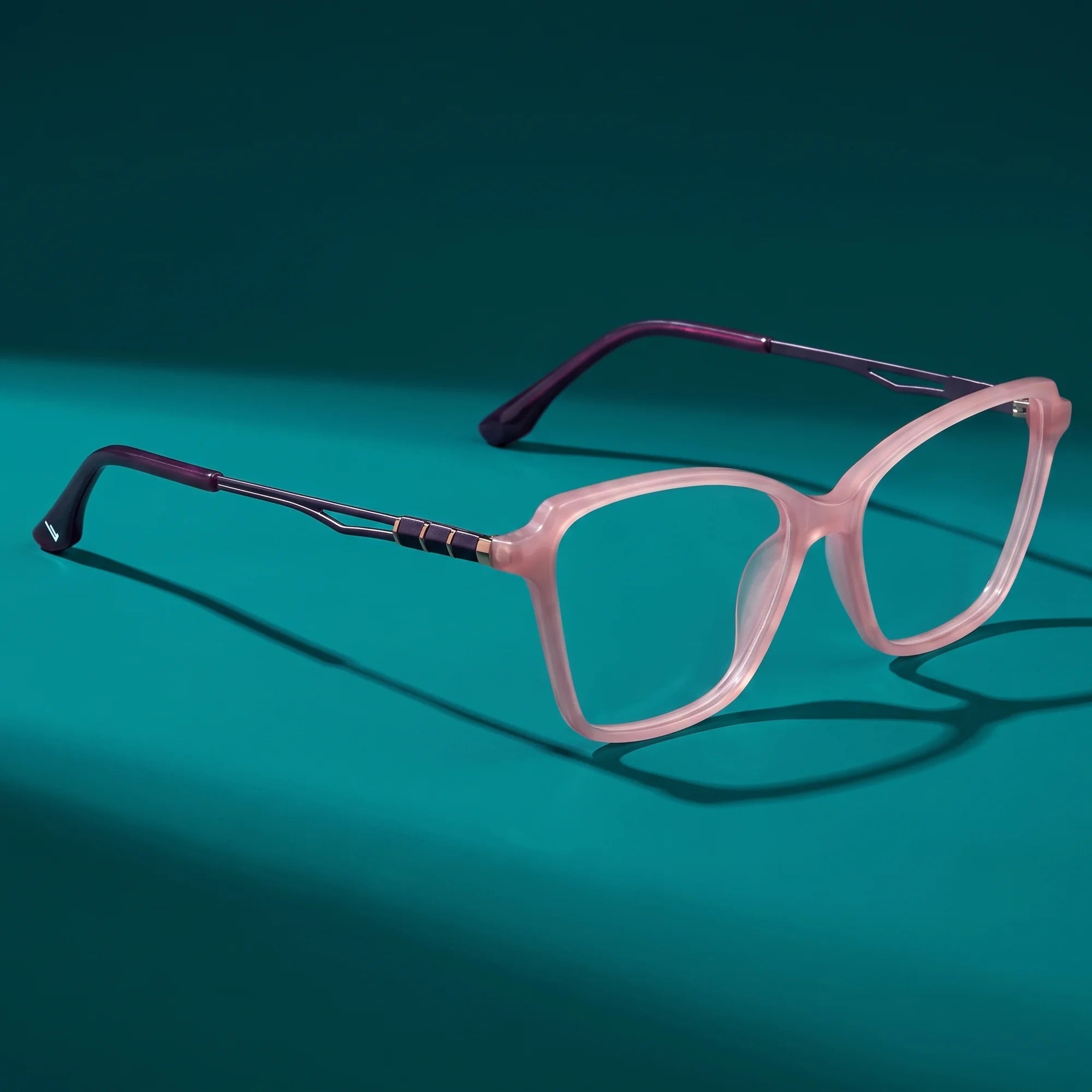 Fiore 1006 eyeglasses in pink – hero still life against a deep teal backdrop