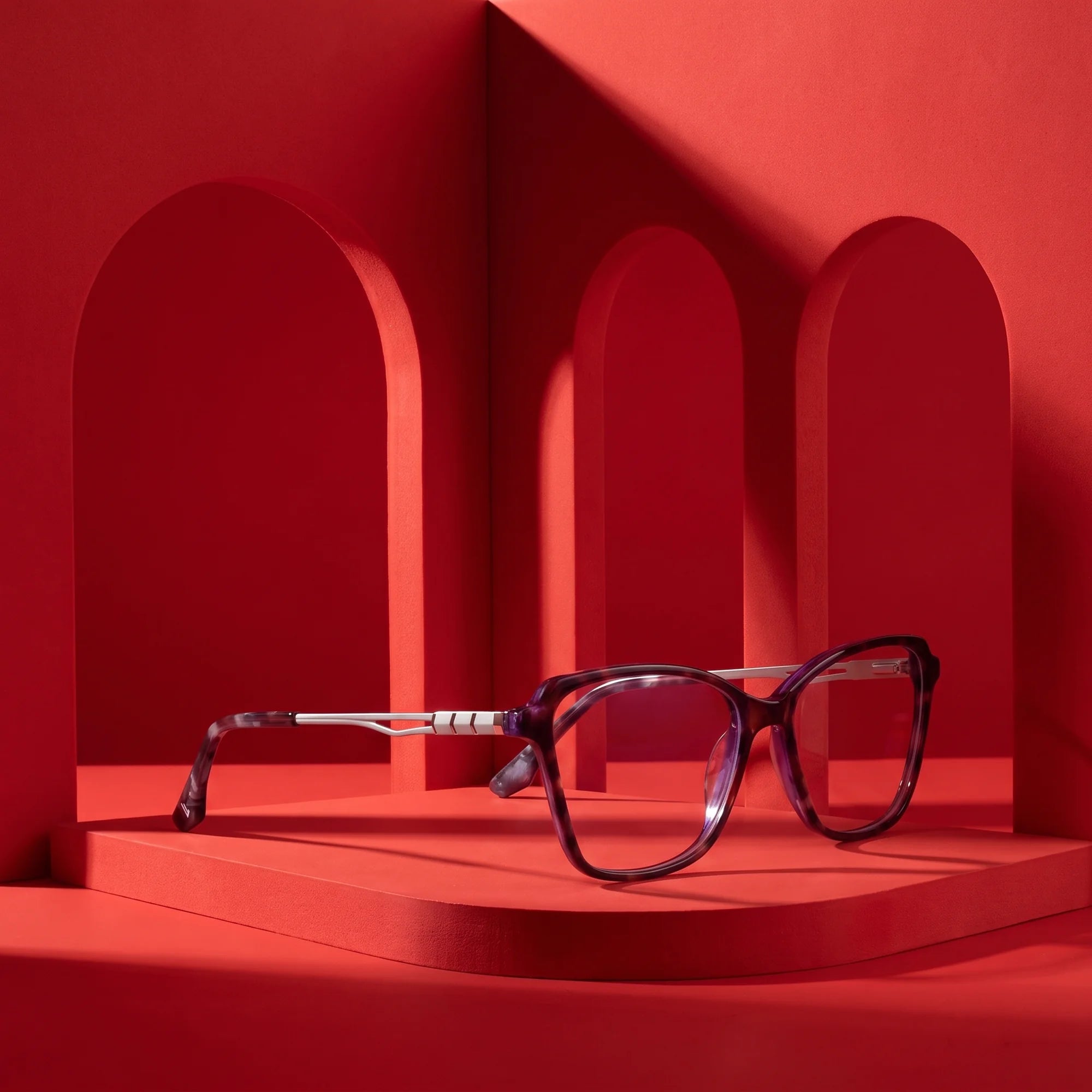 Fiore 1006 eyeglasses in purple – still life among monochrome vivid red arches
