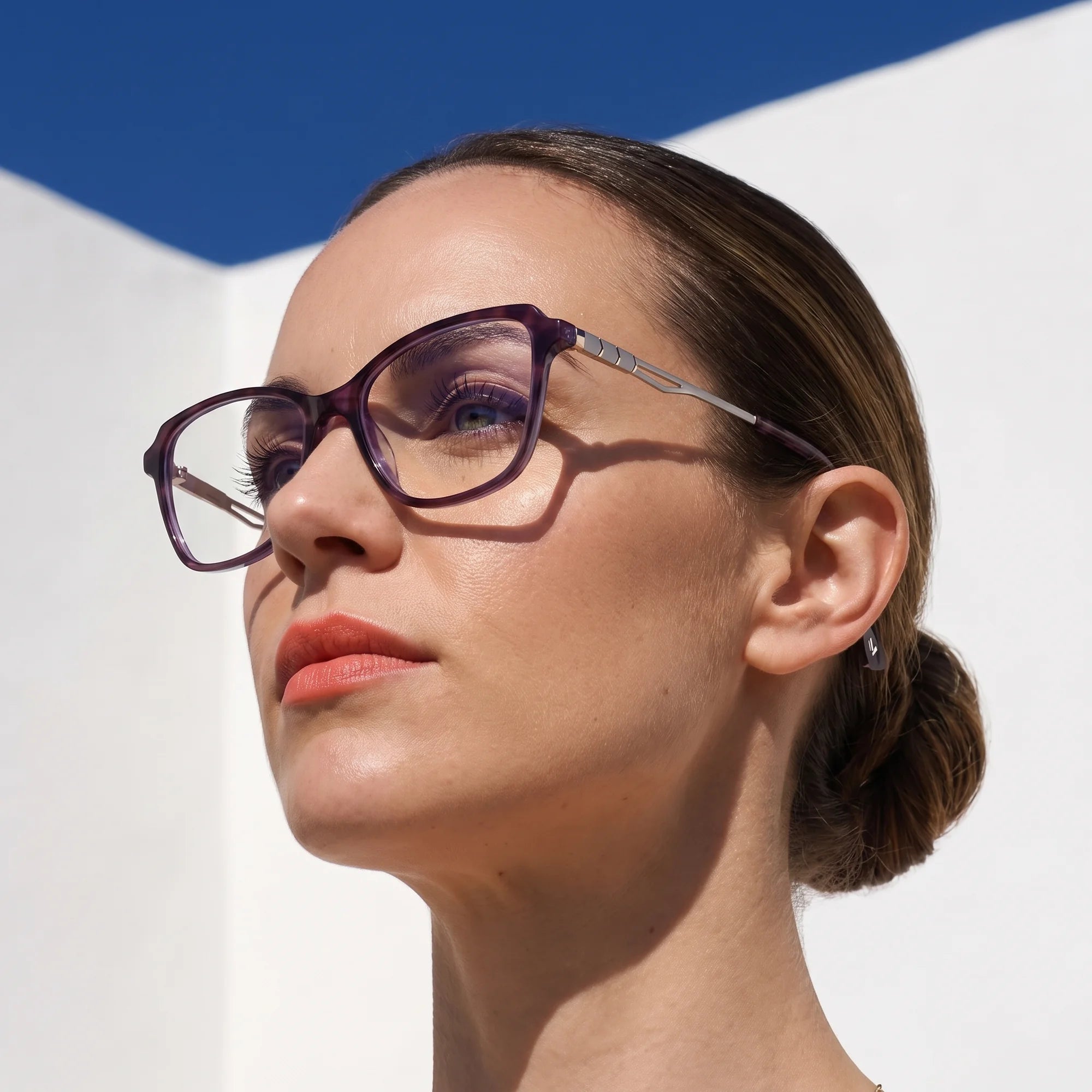 Fiore 1006 eyeglasses in purple, worn by a model – campaign portrait, sunlit Balearic whitewash and deep blue sky
