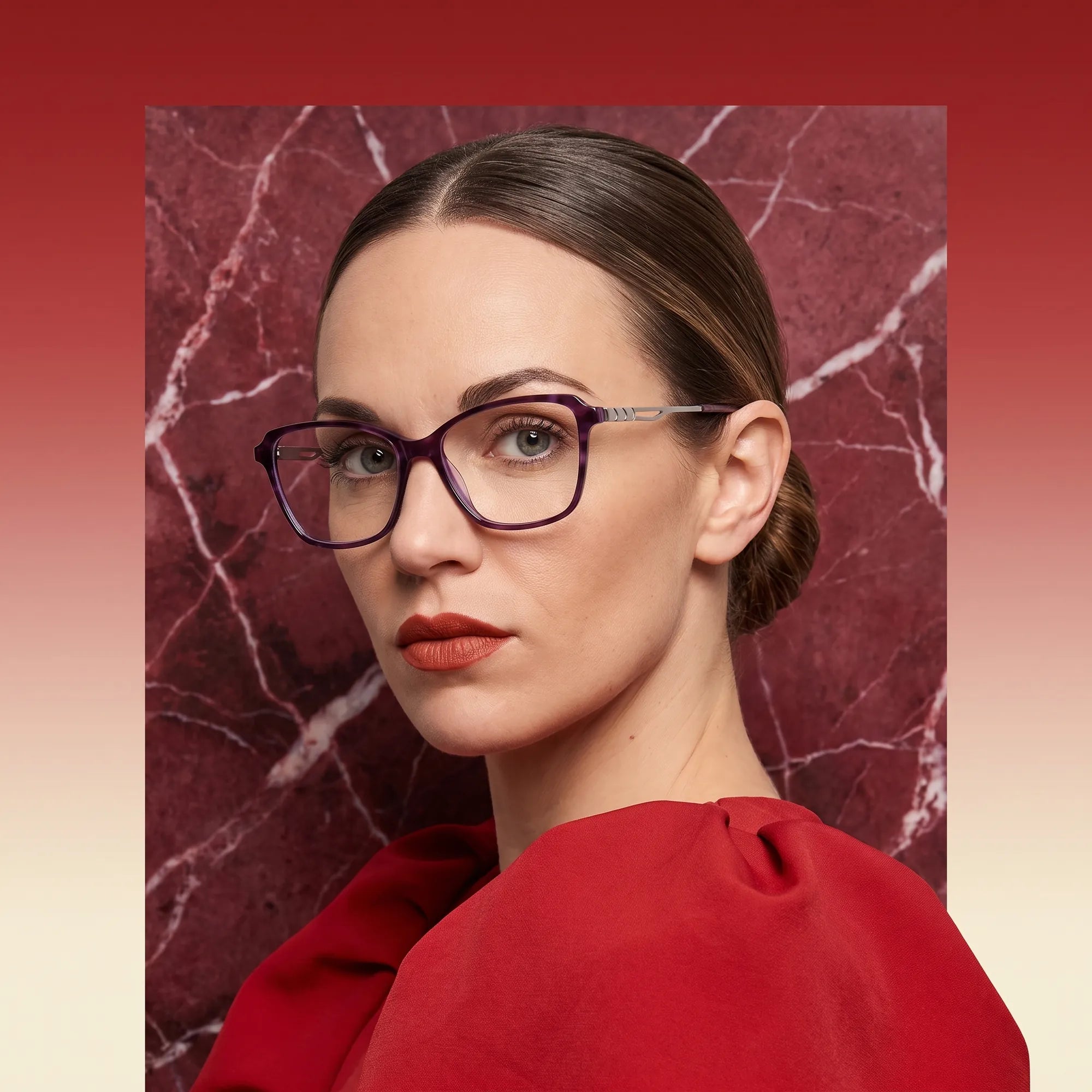 Fiore 1006 eyeglasses in purple, worn by a model – campaign portrait, red marble backdrop and draped scarlet dress