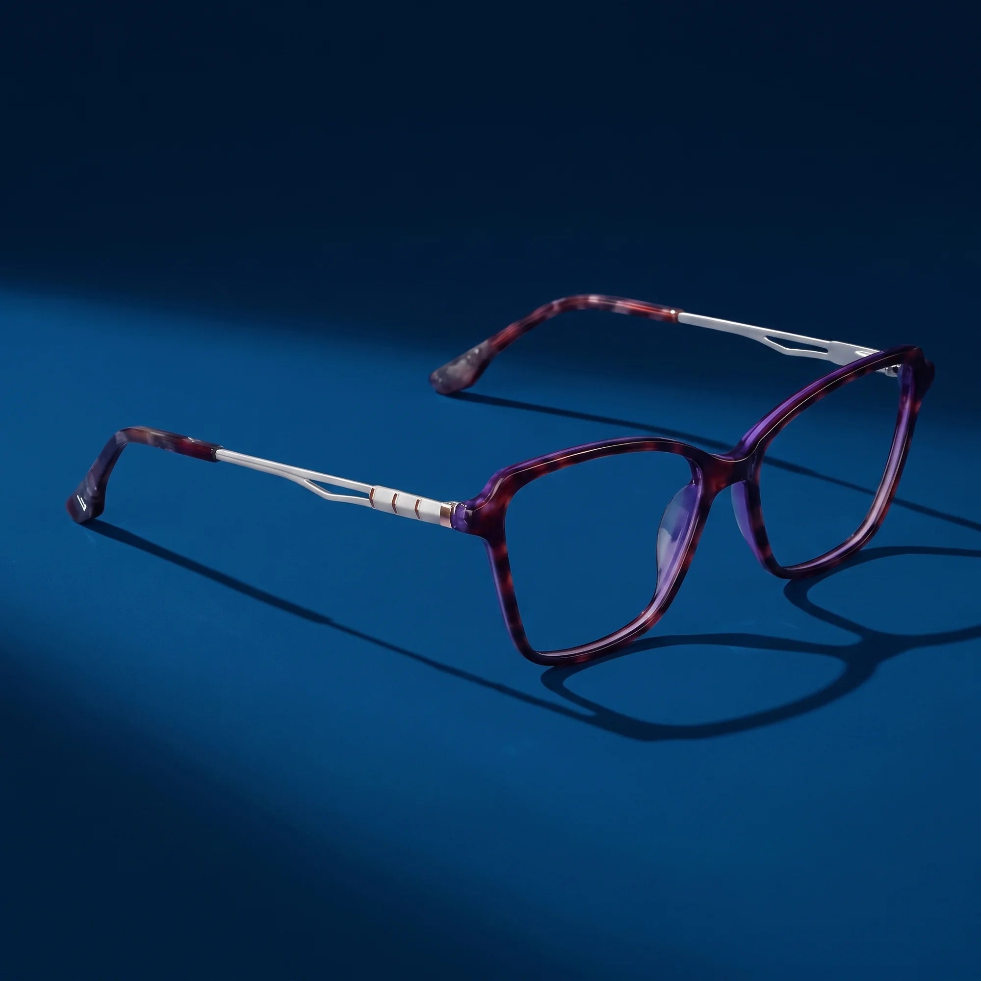Fiore 1006 eyeglasses in purple – hero still life against a deep midnight blue backdrop