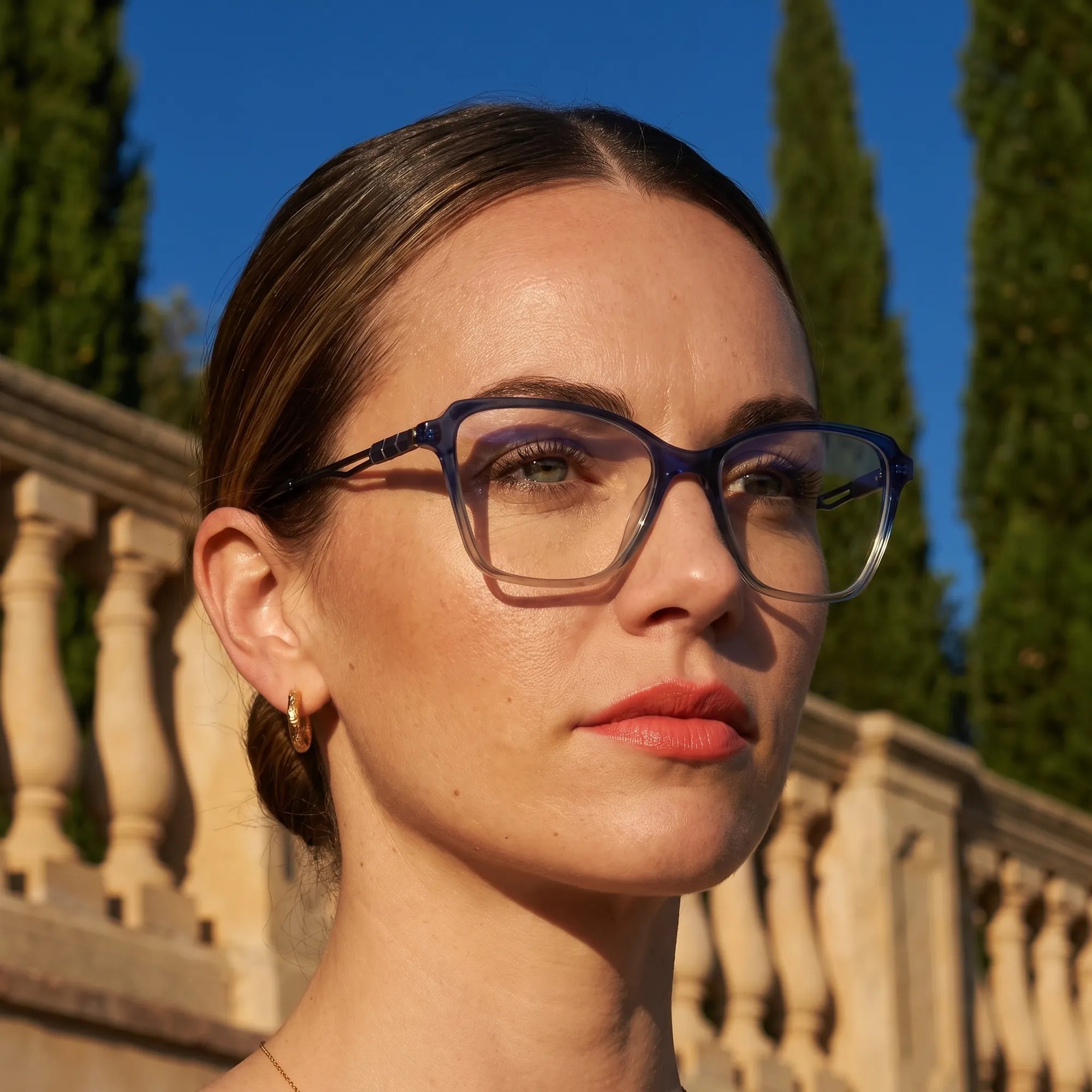 Fiore 1006 eyeglasses in blue, worn by a model – campaign portrait, golden-hour Italian villa terrace