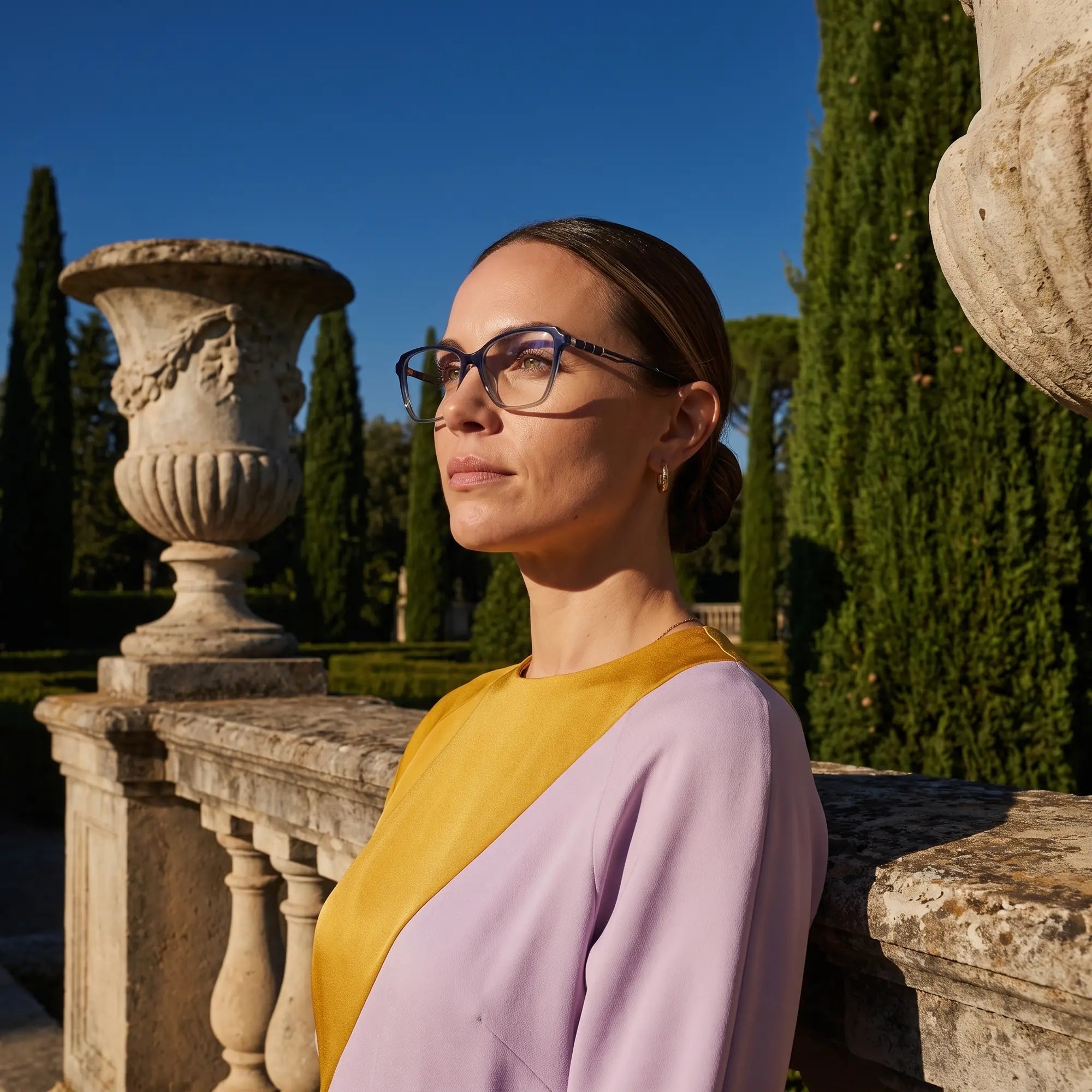 Fiore 1006 eyeglasses in blue, worn by a model – campaign portrait, dusk light over a cypress garden