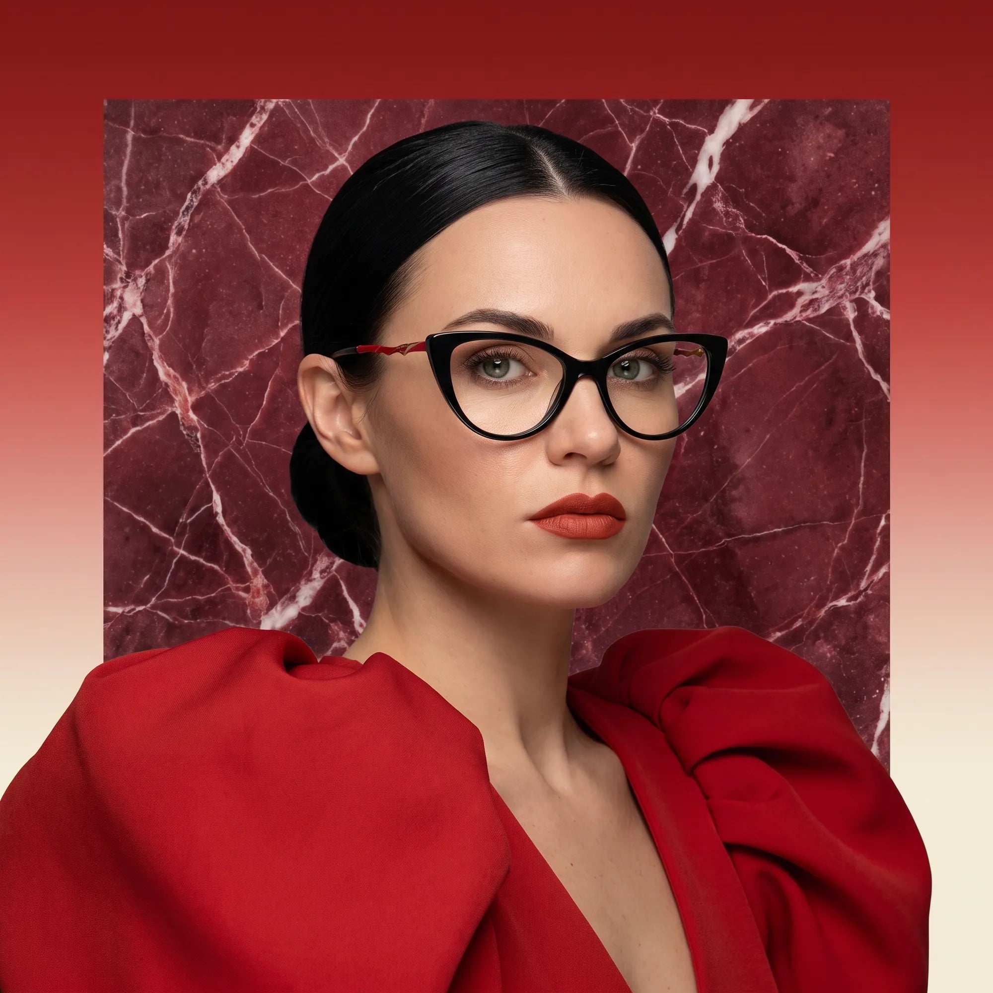 Fiore 1010 eyeglasses in black, worn by a model – campaign portrait, red marble backdrop and draped scarlet dress
