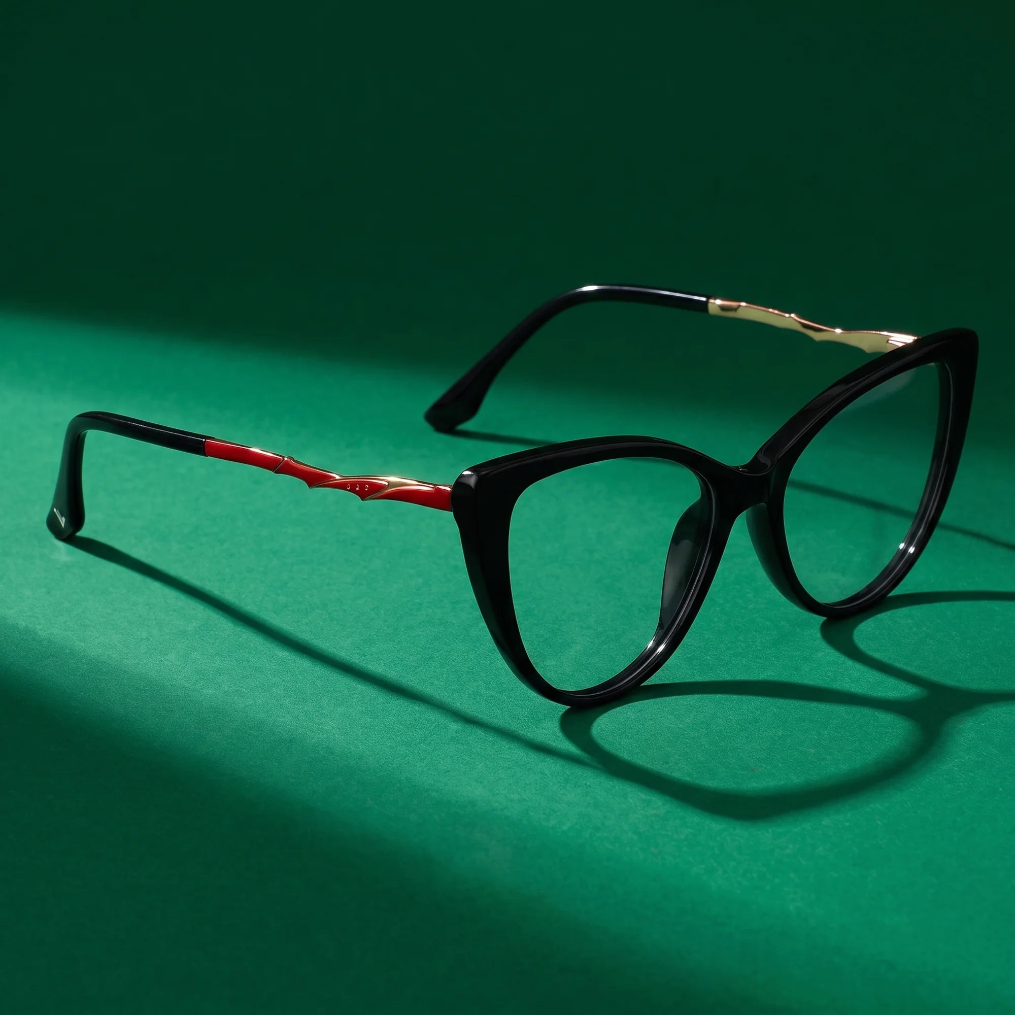 Fiore 1010 eyeglasses in black – editorial still life on a saturated emerald set