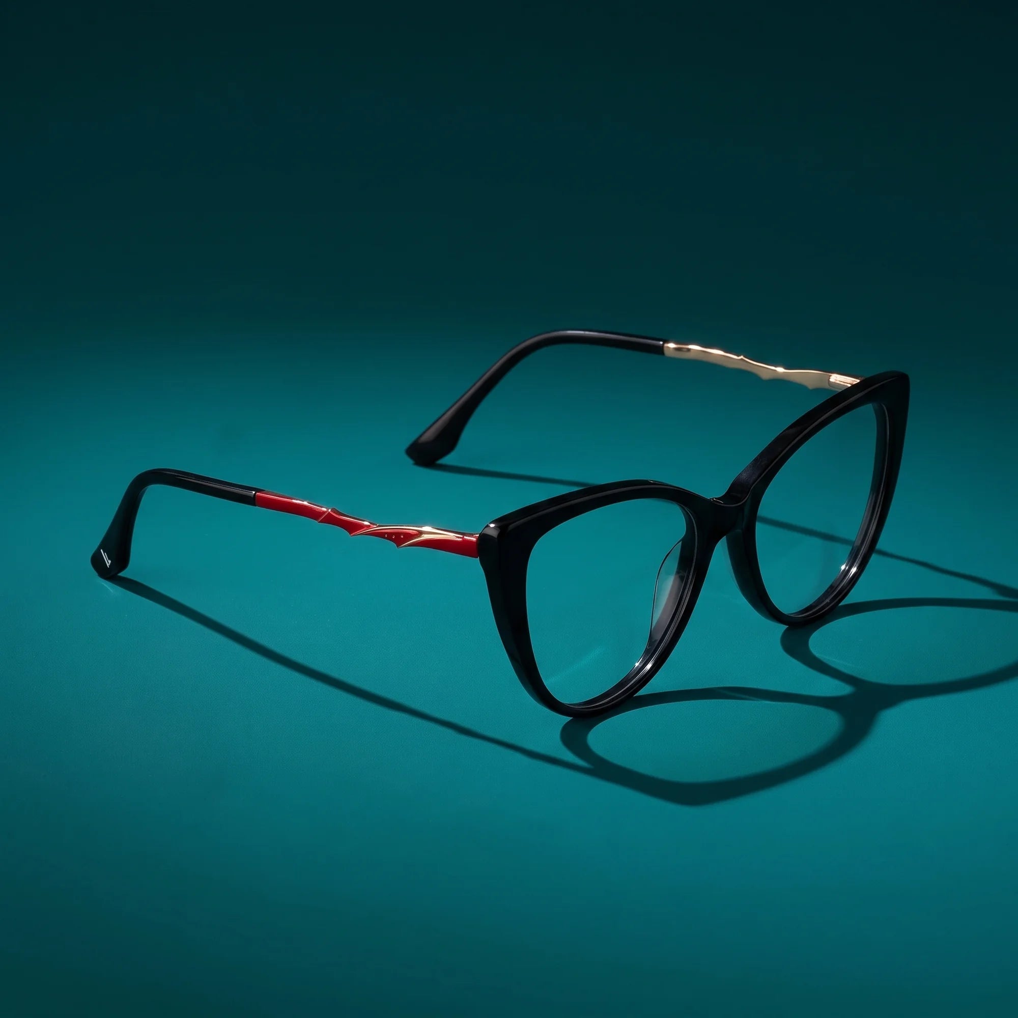 Fiore 1010 eyeglasses in black – hero still life against a deep teal backdrop