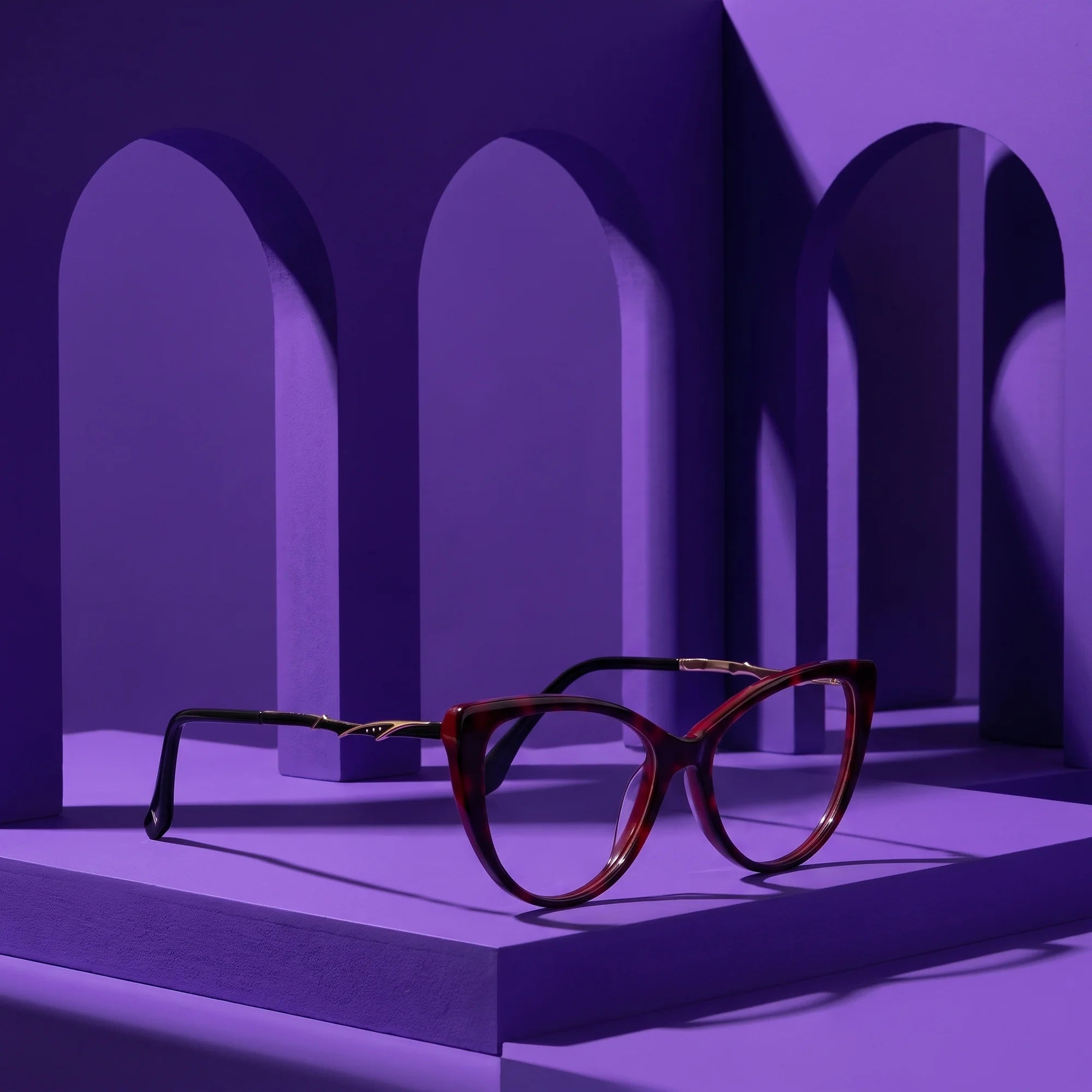 Fiore 1010 eyeglasses in red – still life among monochrome violet arches