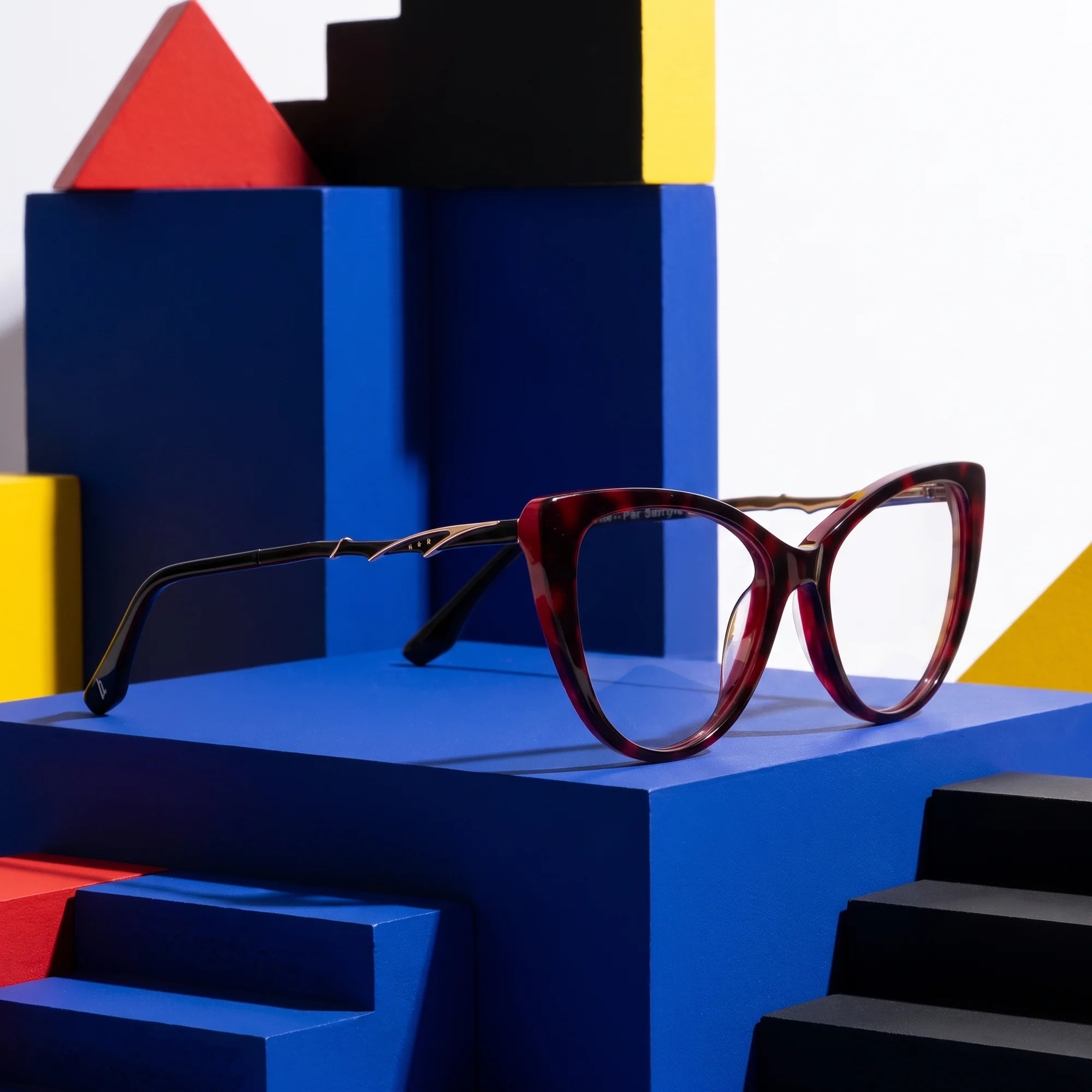 Fiore 1010 eyeglasses in red – on bold primary color-block steps