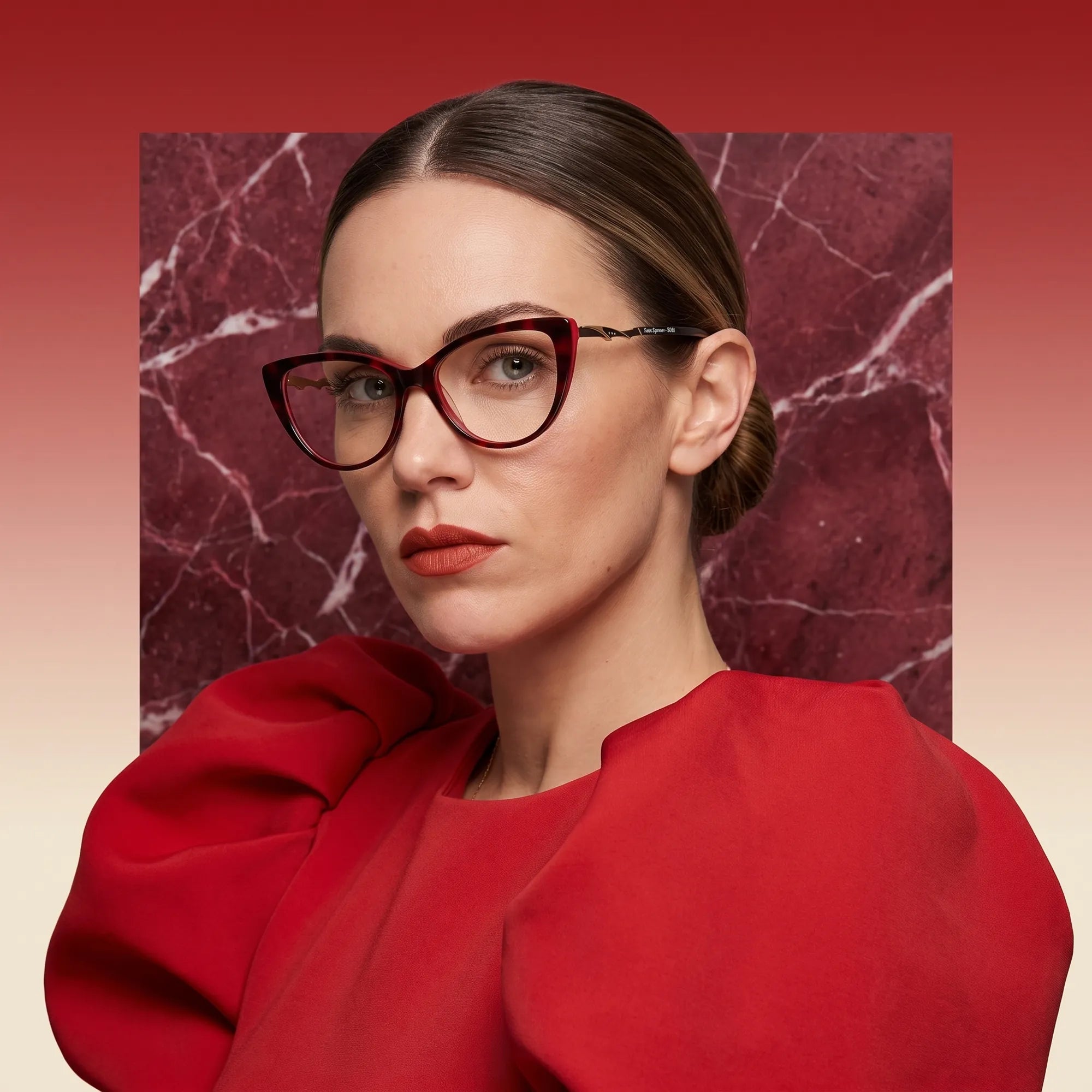 Fiore 1010 eyeglasses in red, worn by a model – campaign portrait, red marble backdrop and draped scarlet dress