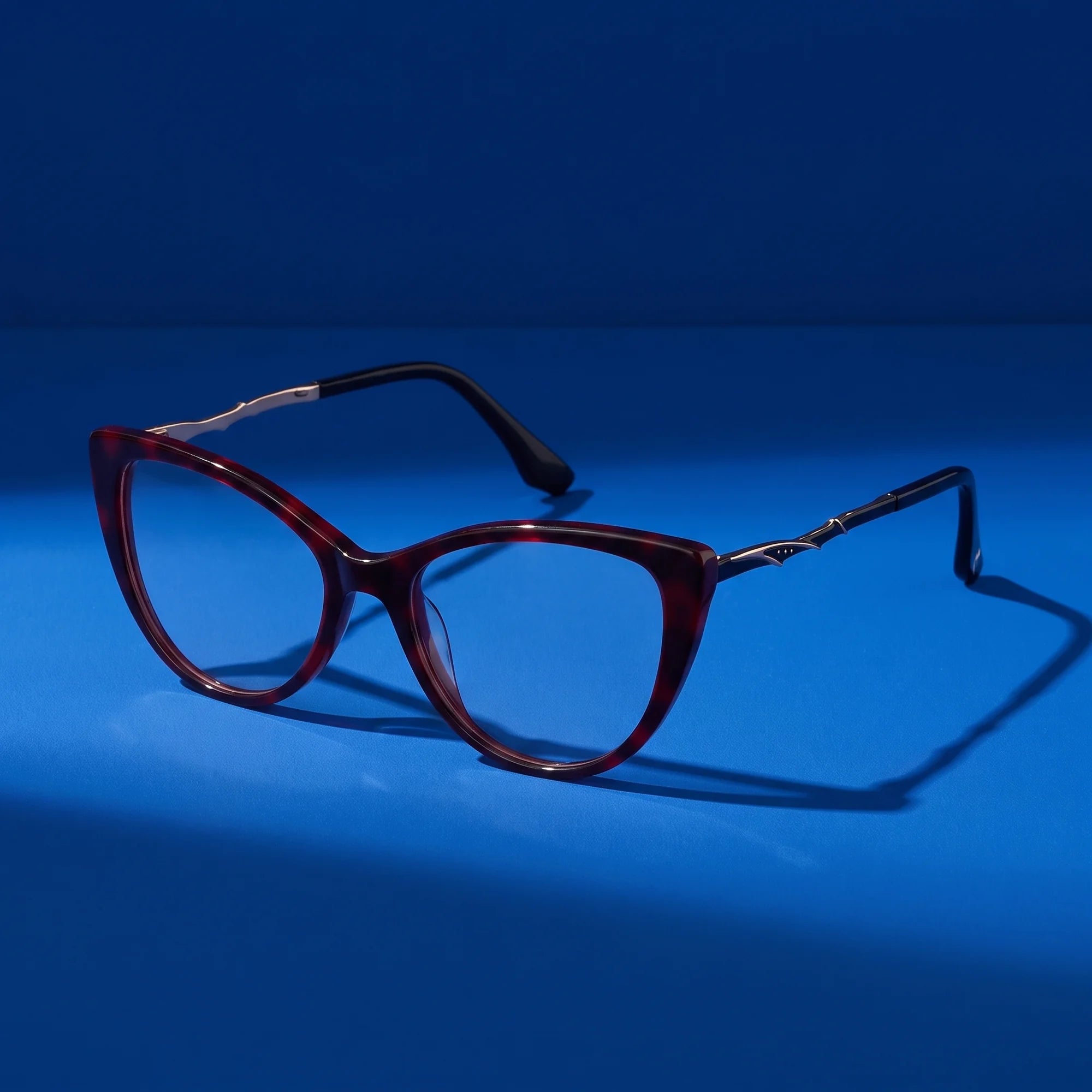 Fiore 1010 eyeglasses in red – still life on a seamless cobalt studio backdrop