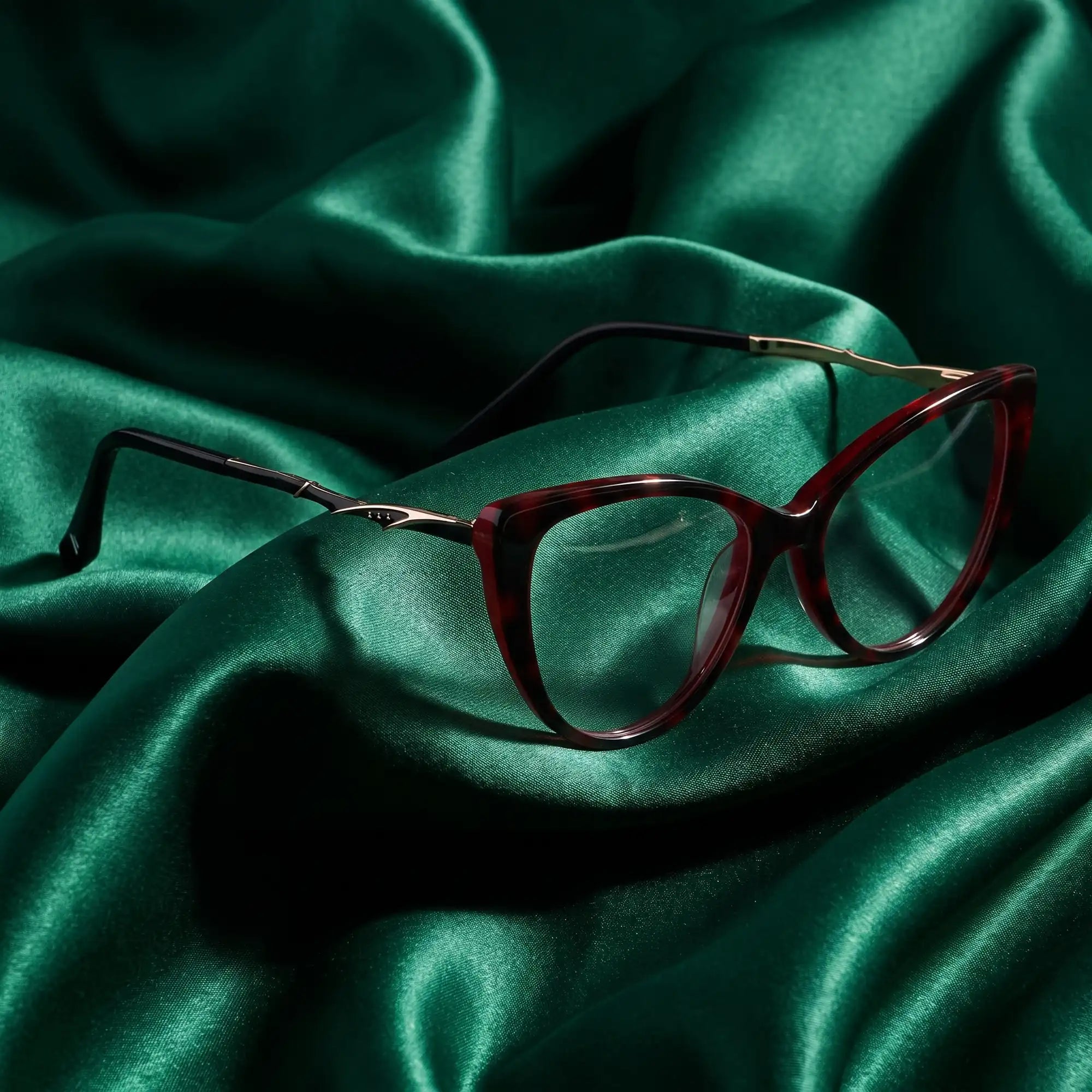 Fiore 1010 eyeglasses in red – nested in flowing emerald silk