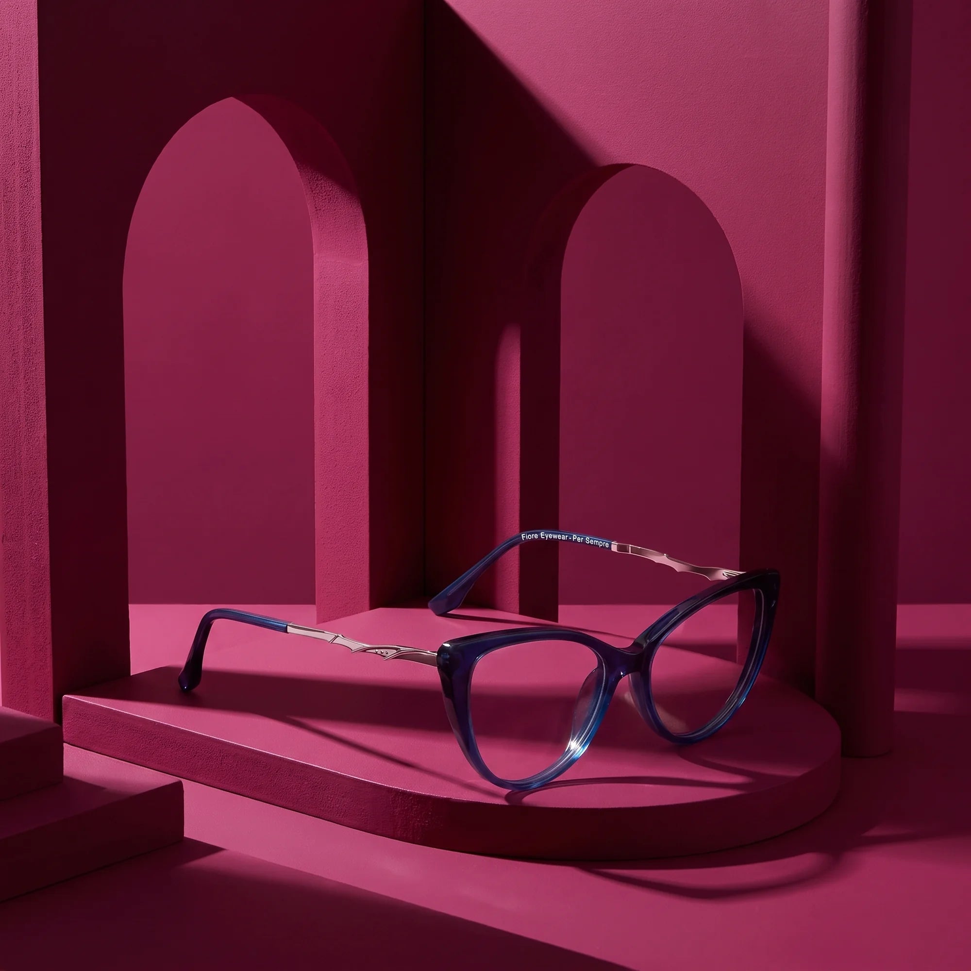 Fiore 1010 eyeglasses in blue – still life among monochrome magenta arches