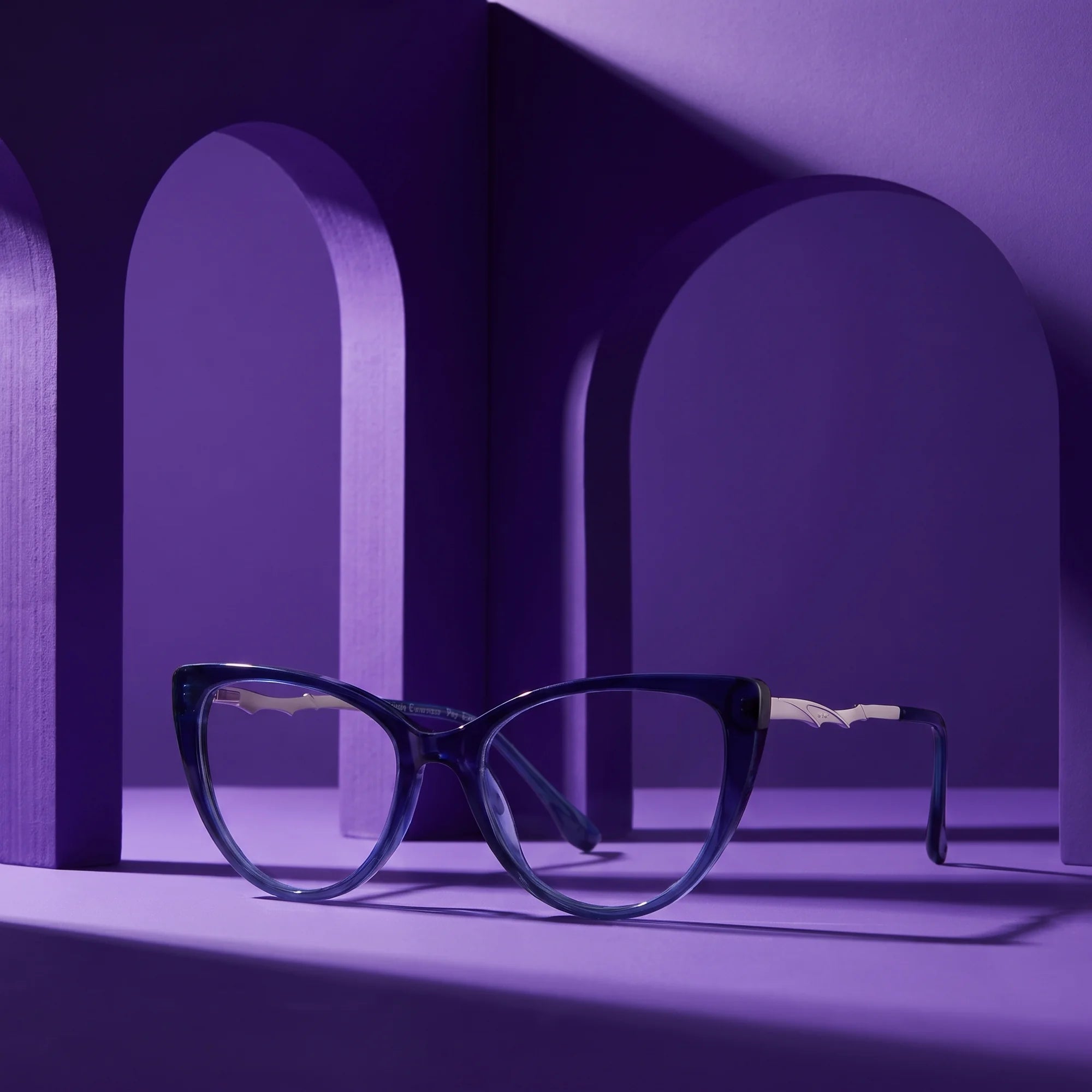 Fiore 1010 eyeglasses in blue – staged on a sculptural violet architecture set