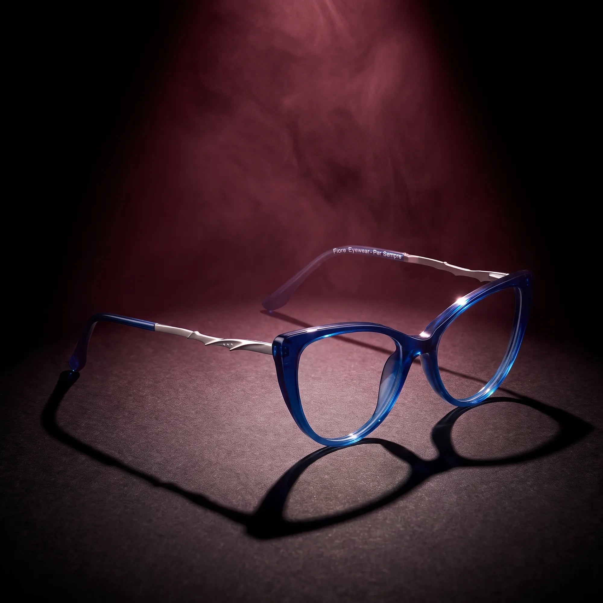 Fiore 1010 eyeglasses in blue – under a theatrical beam of light