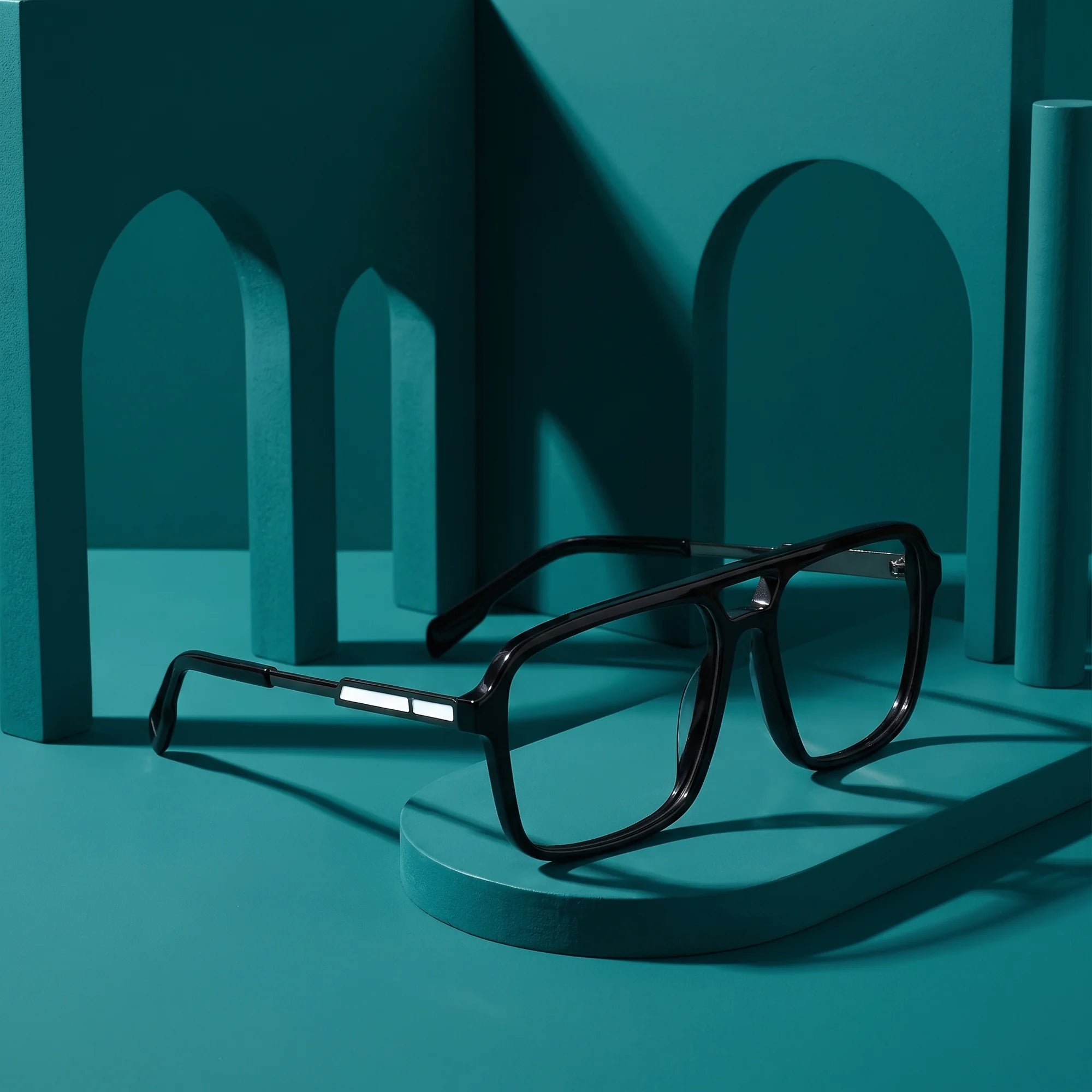 Fiore 1014 eyeglasses in black – still life among monochrome teal arches