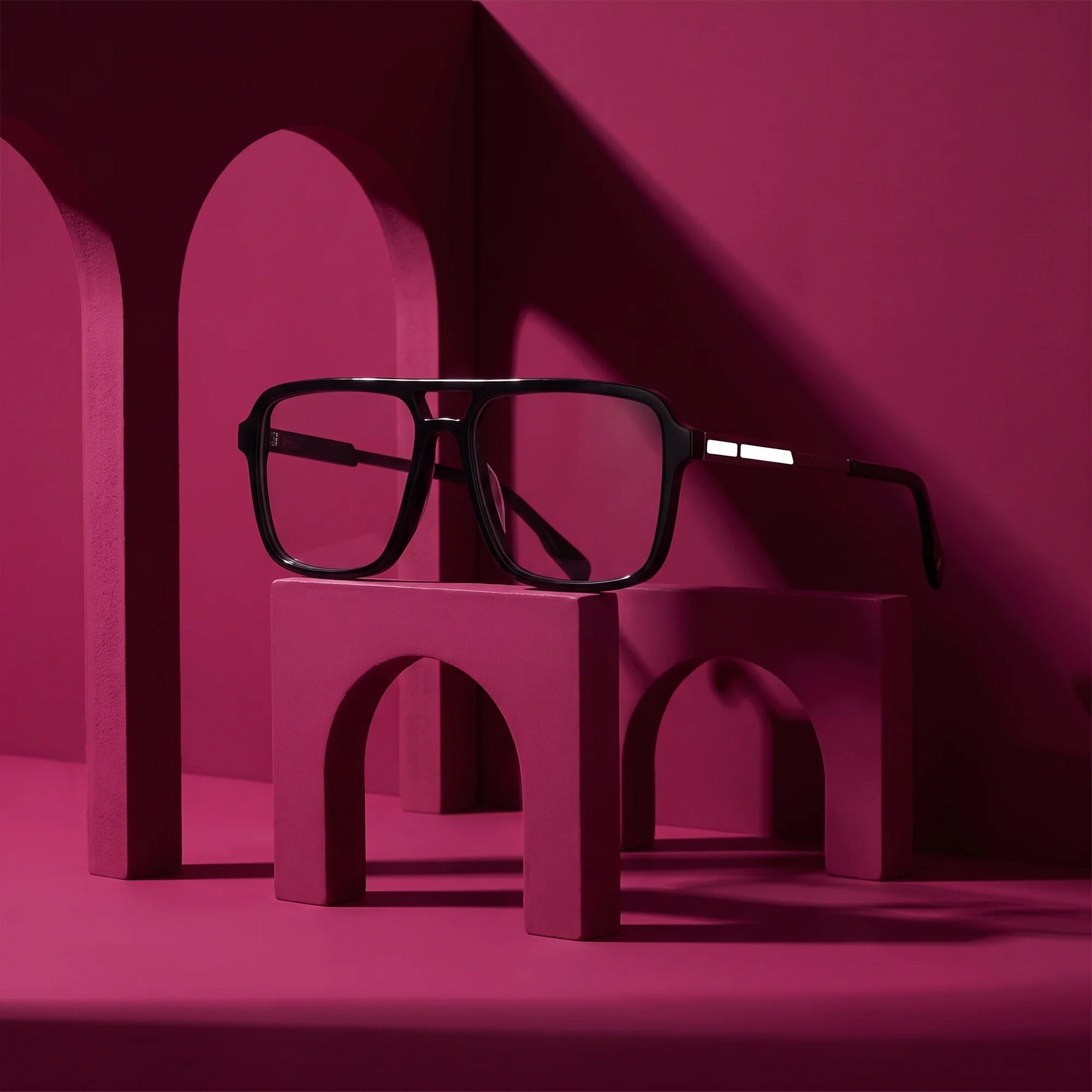 Fiore 1014 eyeglasses in black – staged on a sculptural magenta architecture set