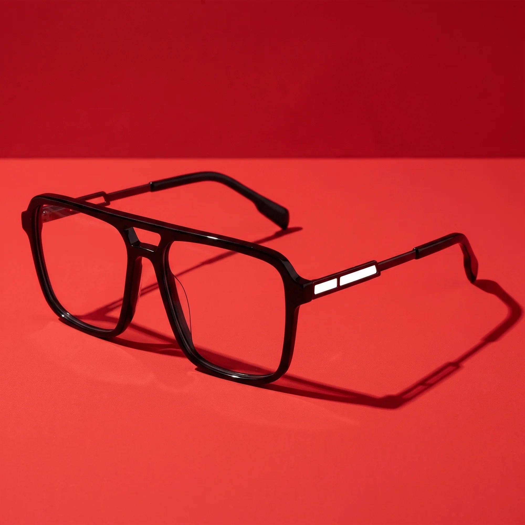 Fiore 1014 eyeglasses in black – editorial still life on a saturated vivid red set