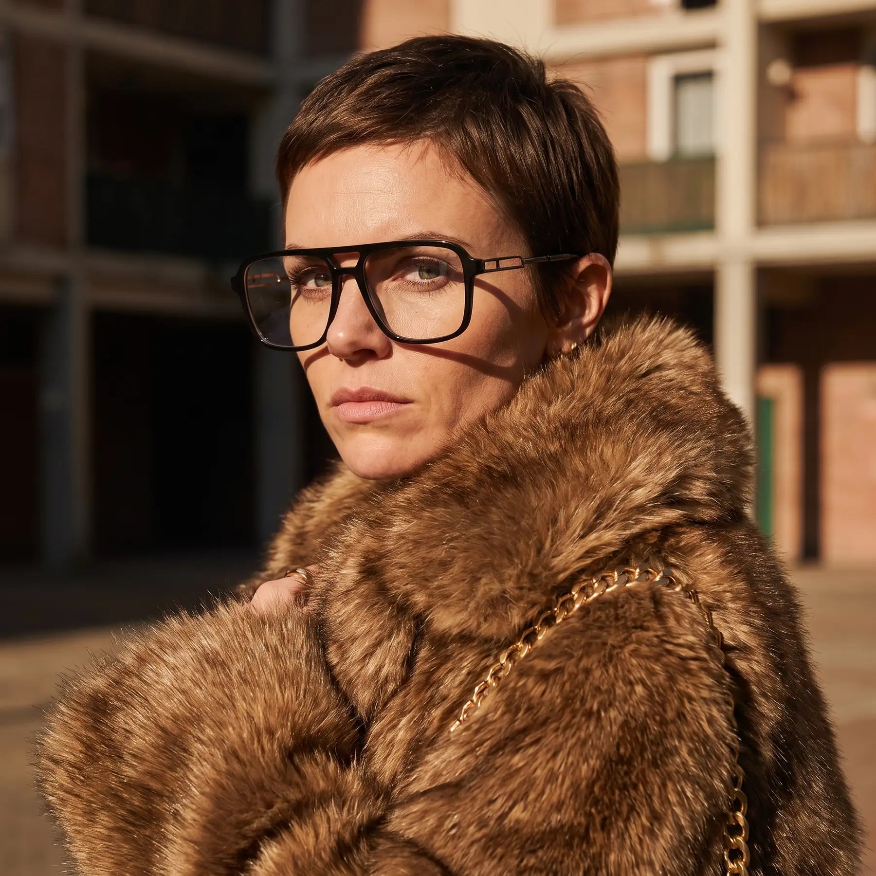 Fiore 1014 eyeglasses in black, worn by a model – campaign portrait, street portrait rooted in city heritage
