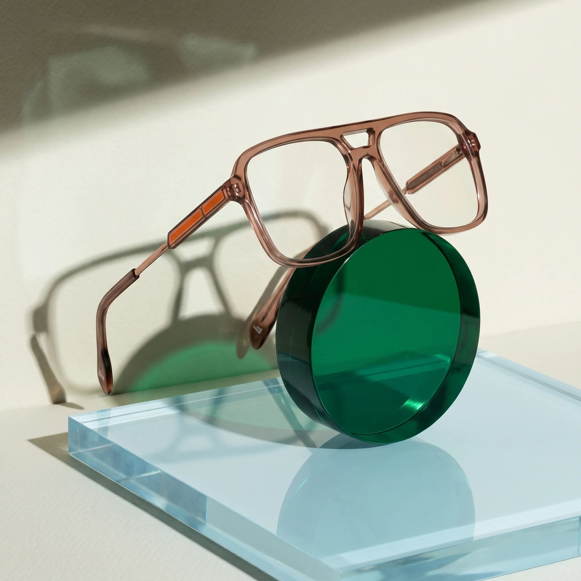 Fiore 1014 eyeglasses in brown – on a cobalt acrylic disc in soft daylight