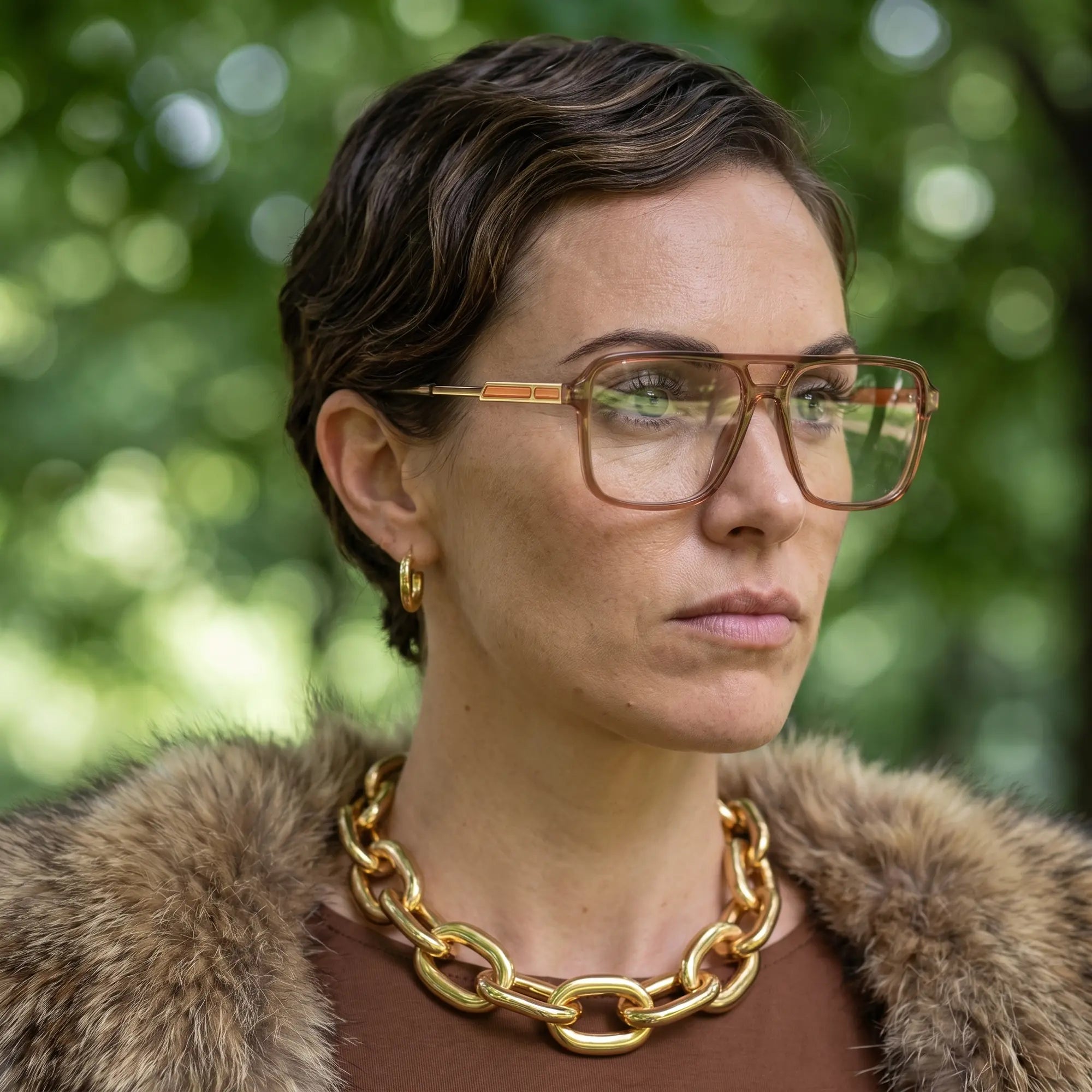 Fiore 1014 eyeglasses in brown, worn by a model – campaign portrait, fur-collar portrait in dappled daylight