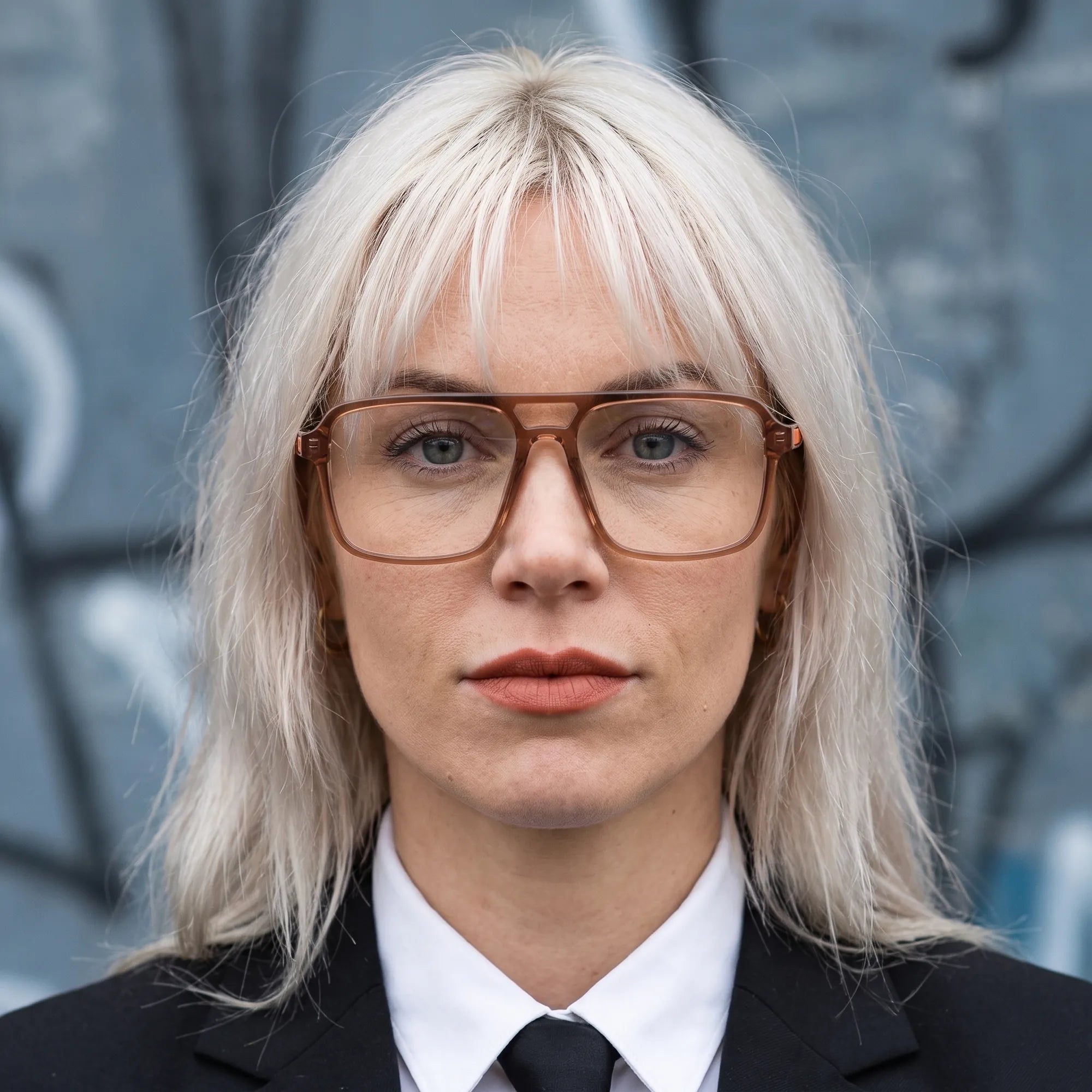 Fiore 1014 eyeglasses in brown, worn by a model – campaign portrait, confident portrait with gold chain necklace