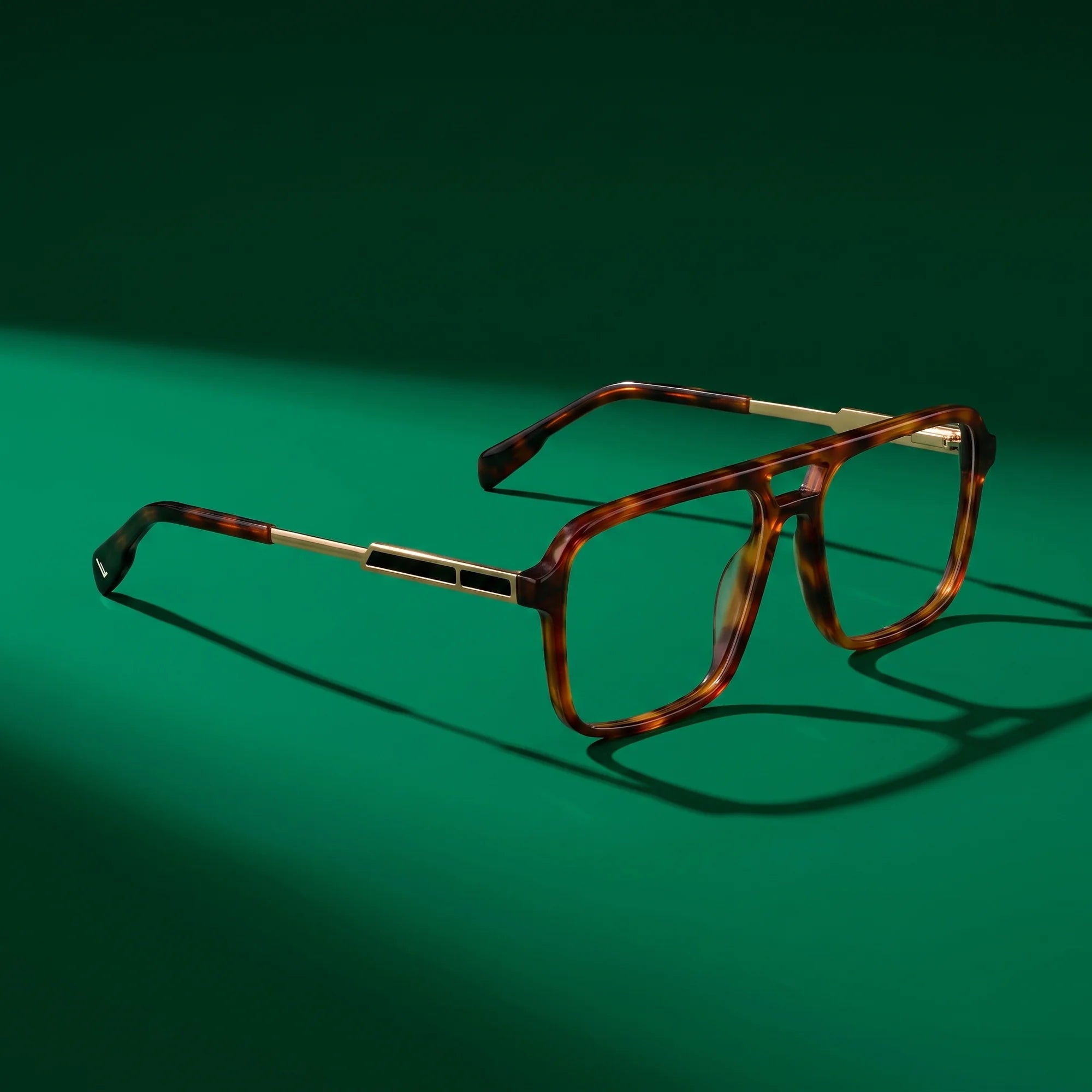 Fiore 1014 eyeglasses in brown tortoiseshell – editorial still life on a saturated emerald set