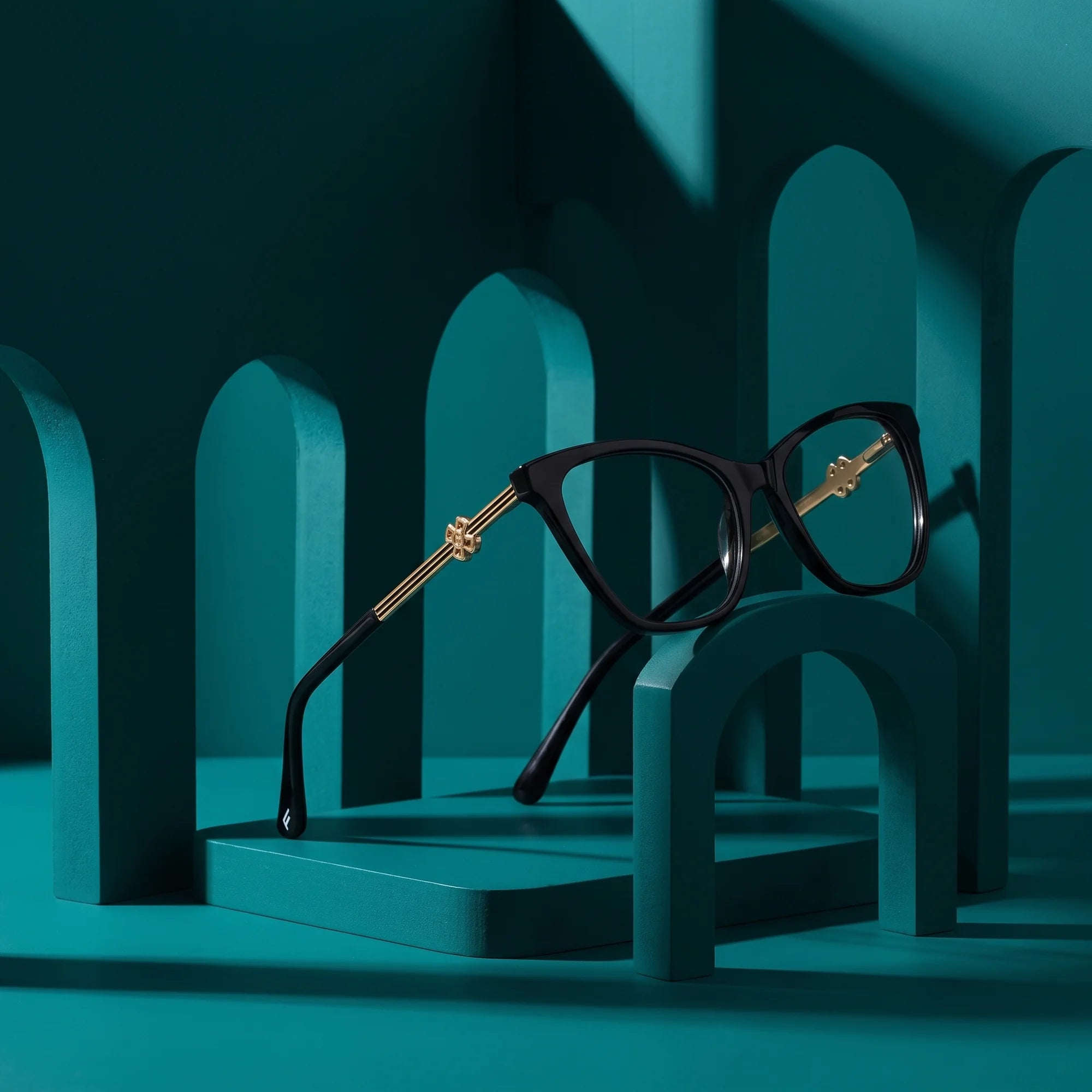Fiore 10172 eyeglasses in black – still life among monochrome teal arches