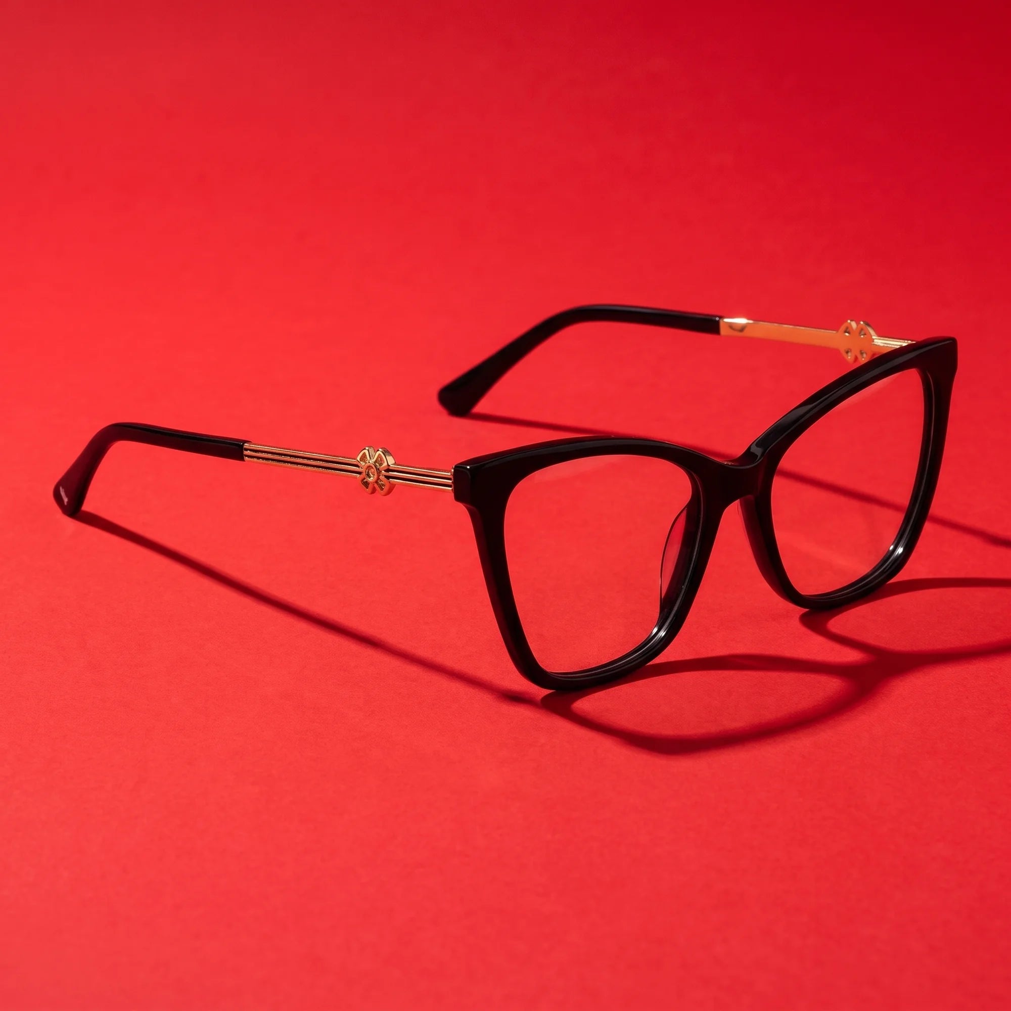 Fiore 10172 eyeglasses in black – editorial still life on a saturated vivid red set