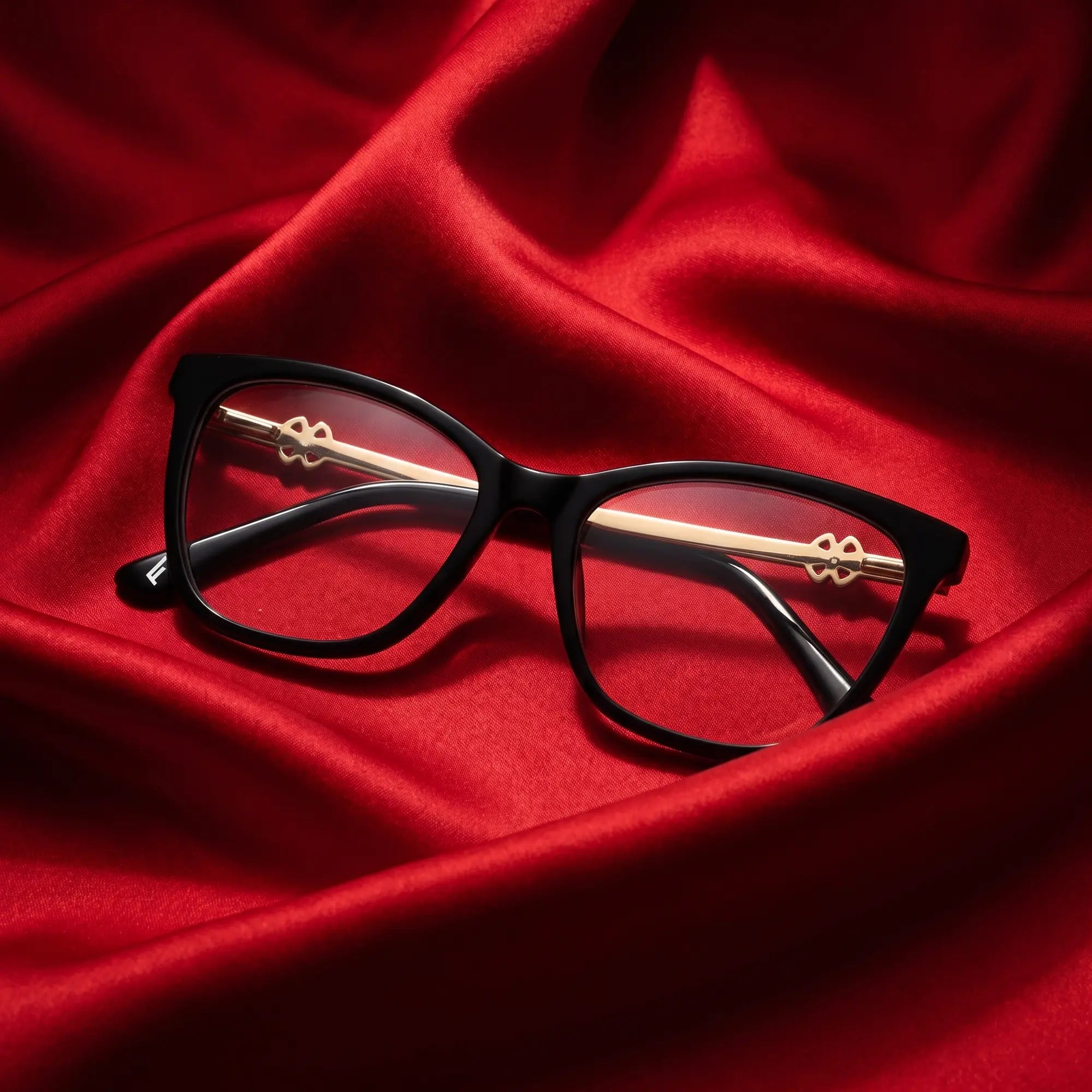 Fiore 10172 eyeglasses in black – nested in flowing vivid red silk