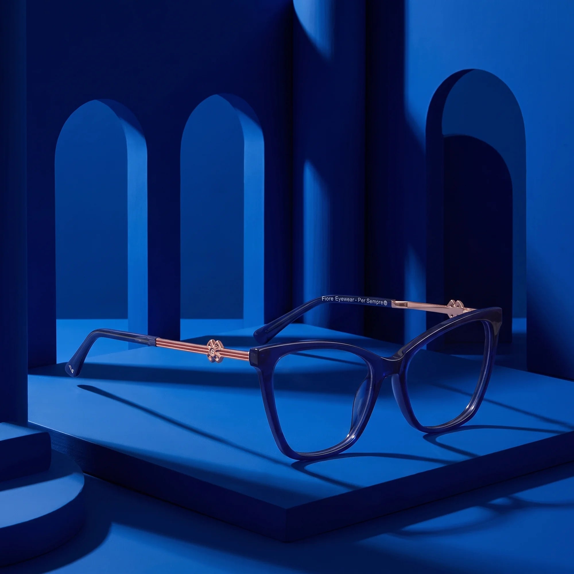 Fiore 10172 eyeglasses in blue – still life among monochrome cobalt arches
