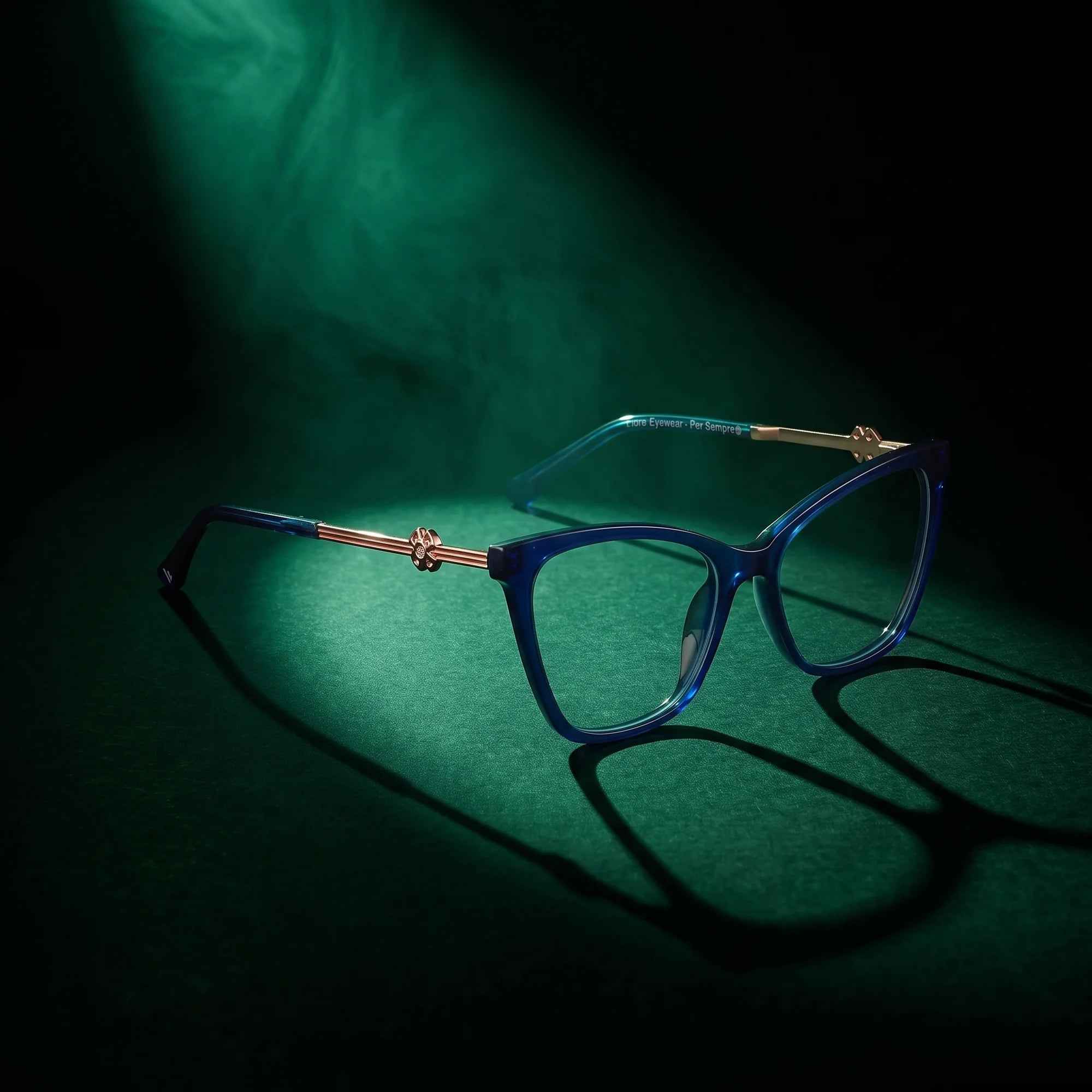 Fiore 10172 eyeglasses in blue – under a theatrical beam of light