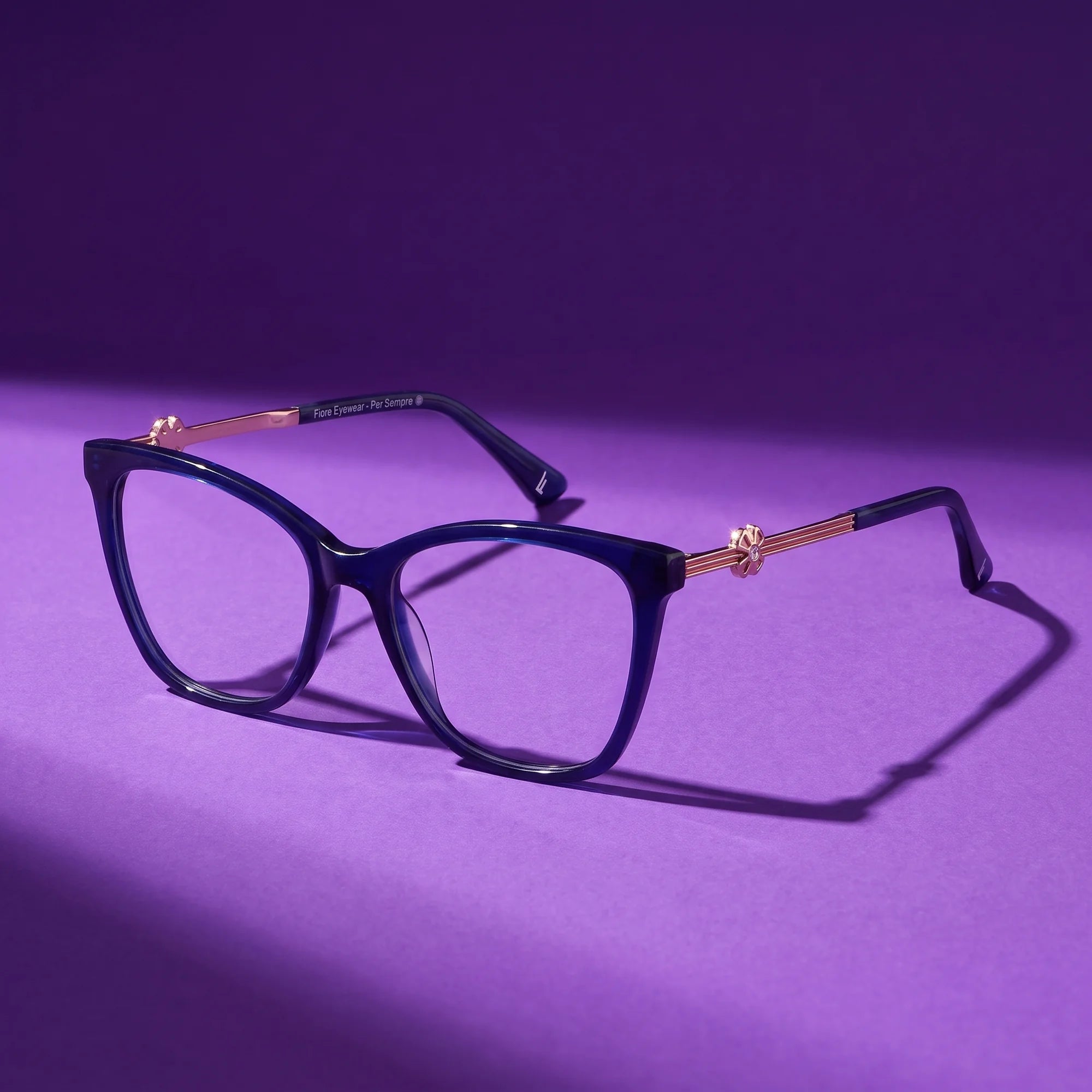 Fiore 10172 eyeglasses in blue – still life on a seamless violet studio backdrop
