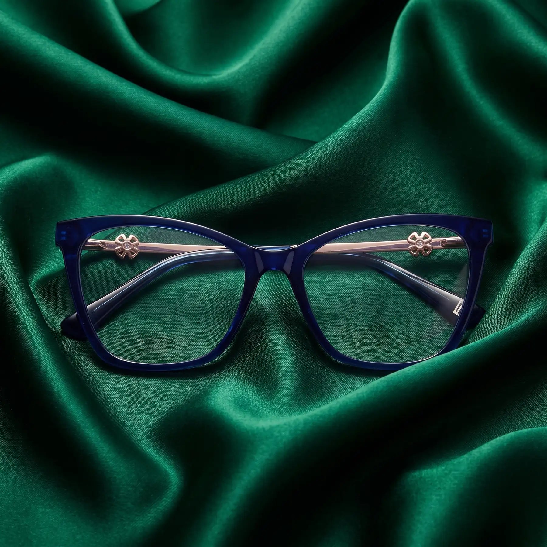 Fiore 10172 eyeglasses in blue – nested in flowing emerald silk