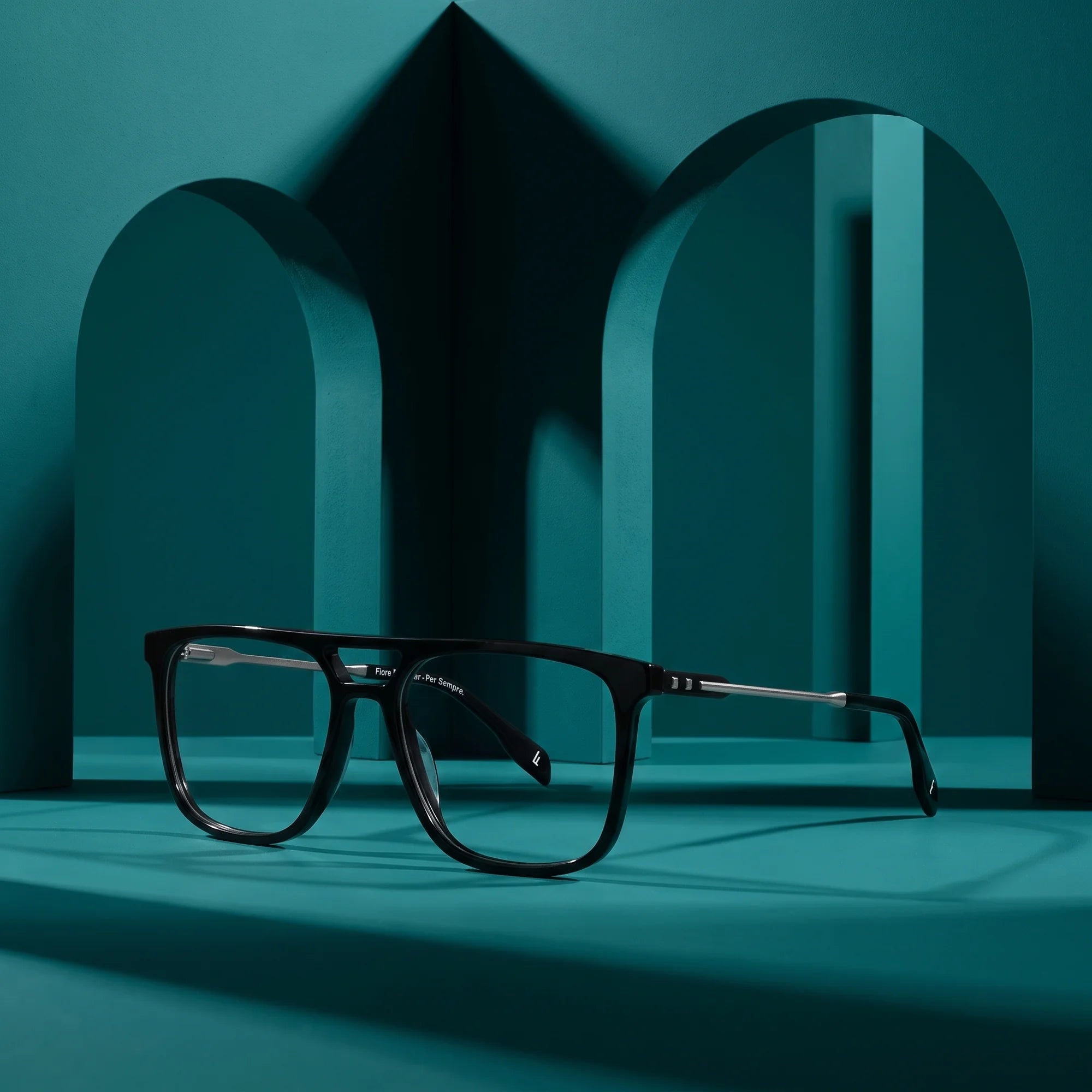 Fiore 10177 eyeglasses in black – still life among monochrome teal arches