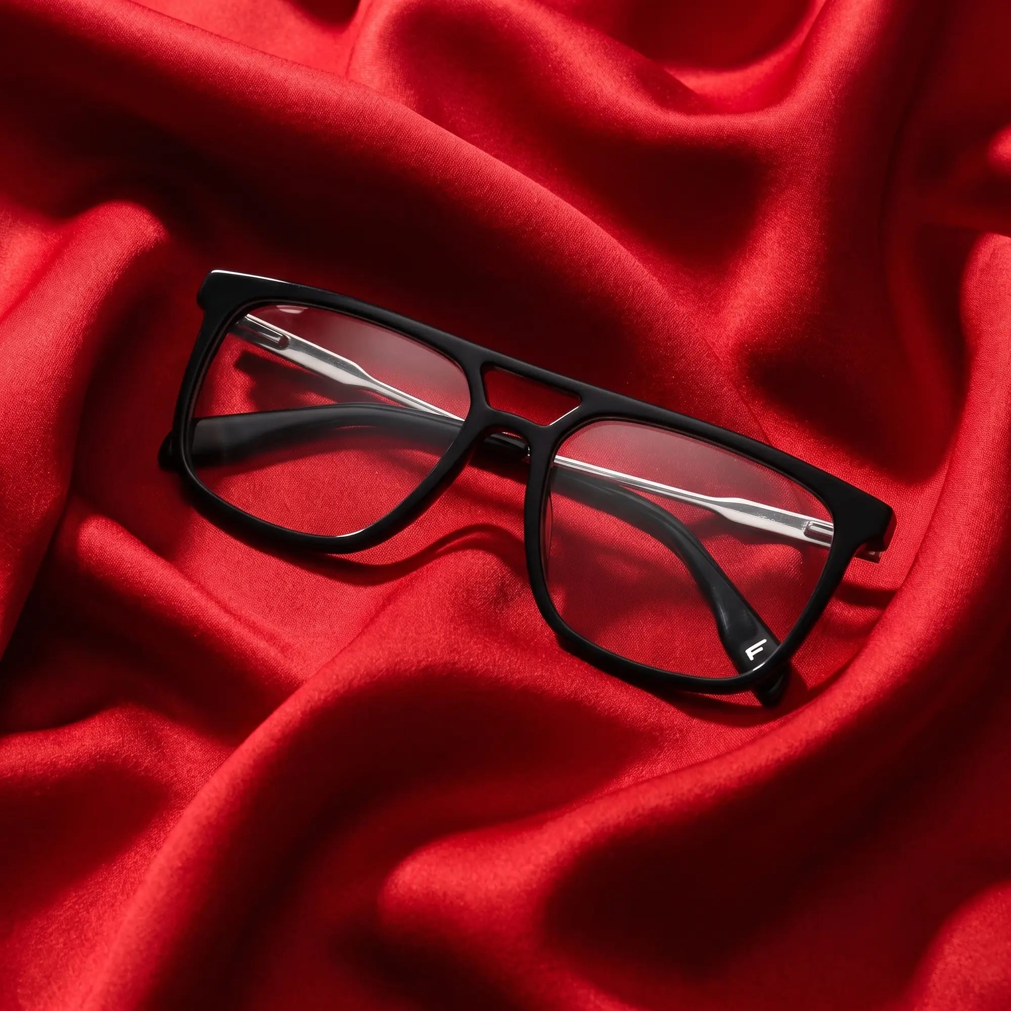 Fiore 10177 eyeglasses in black – nested in flowing vivid red silk