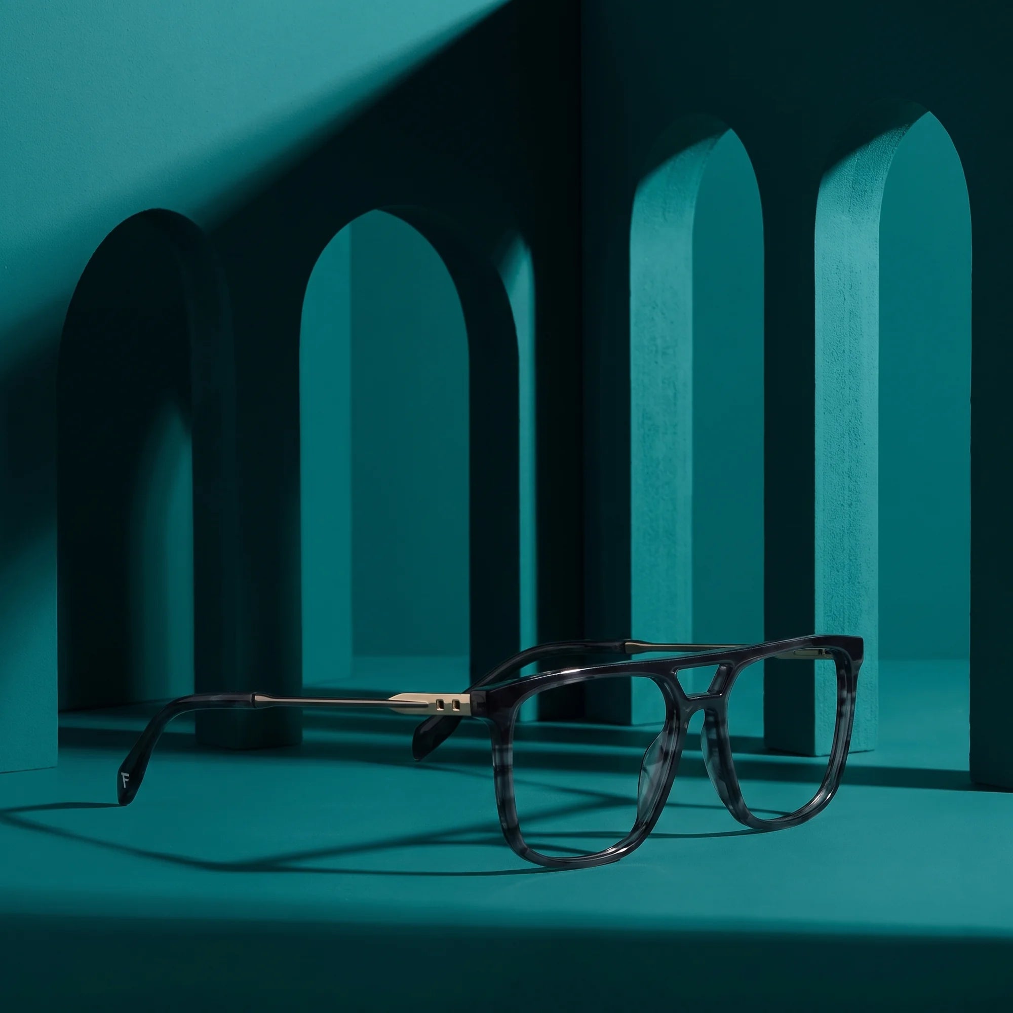 Fiore 10177 eyeglasses in grey – still life among monochrome teal arches