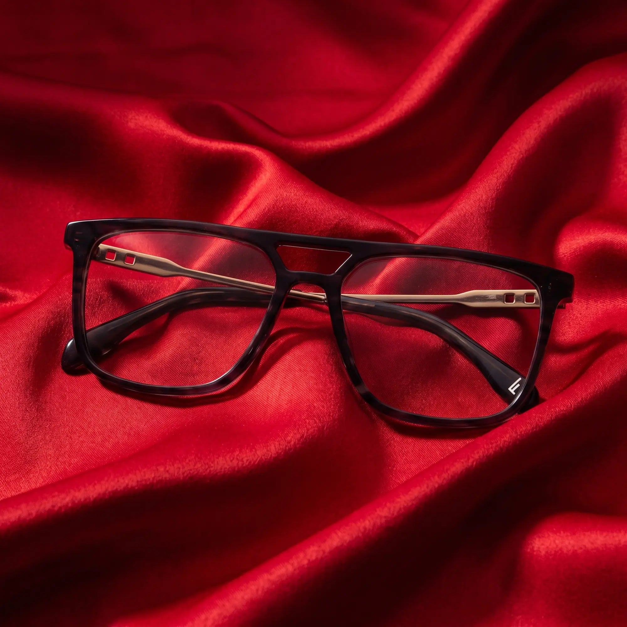 Fiore 10177 eyeglasses in grey – nested in flowing vivid red silk