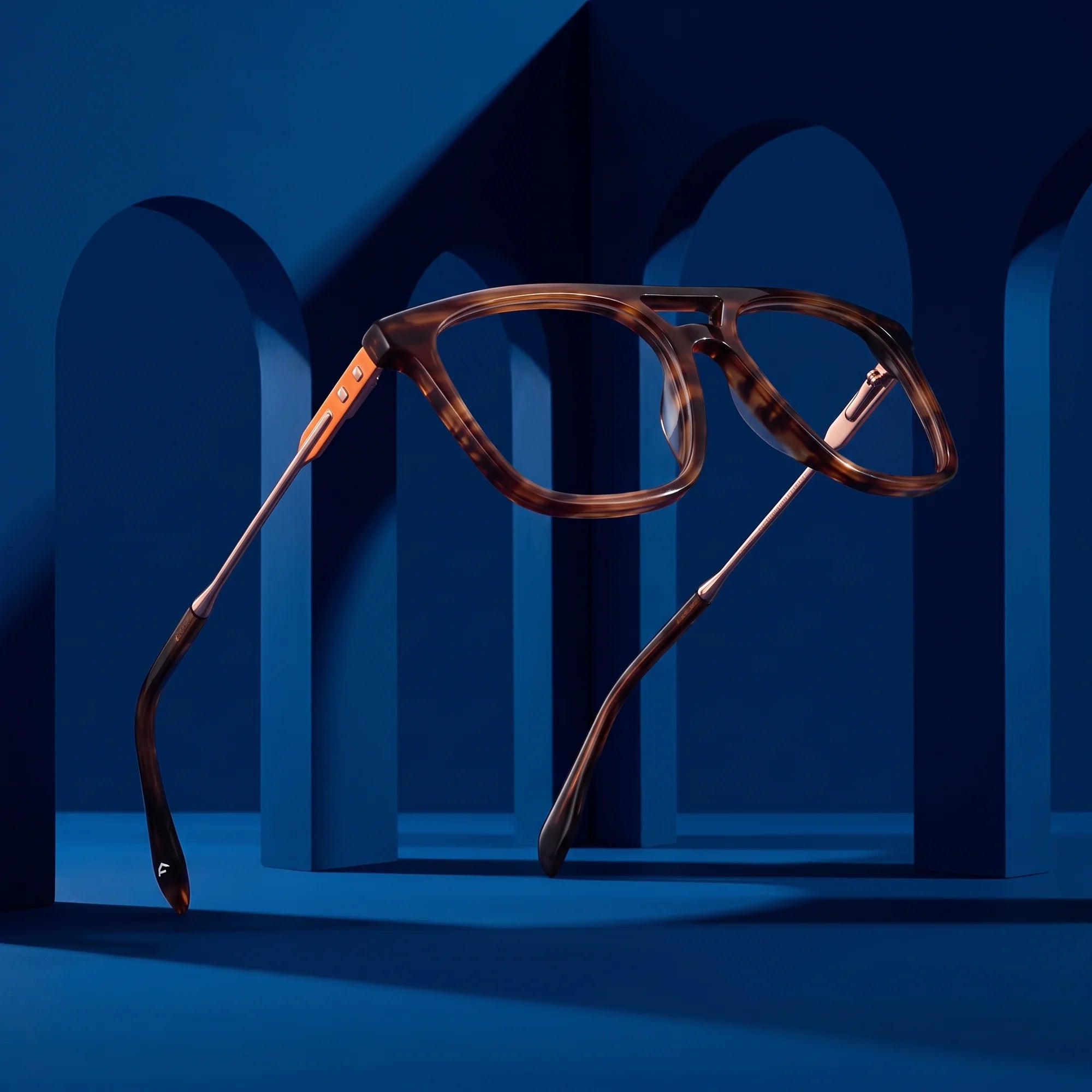 Fiore 10177 eyeglasses in tortoiseshell – displayed on a midnight blue podium among arches