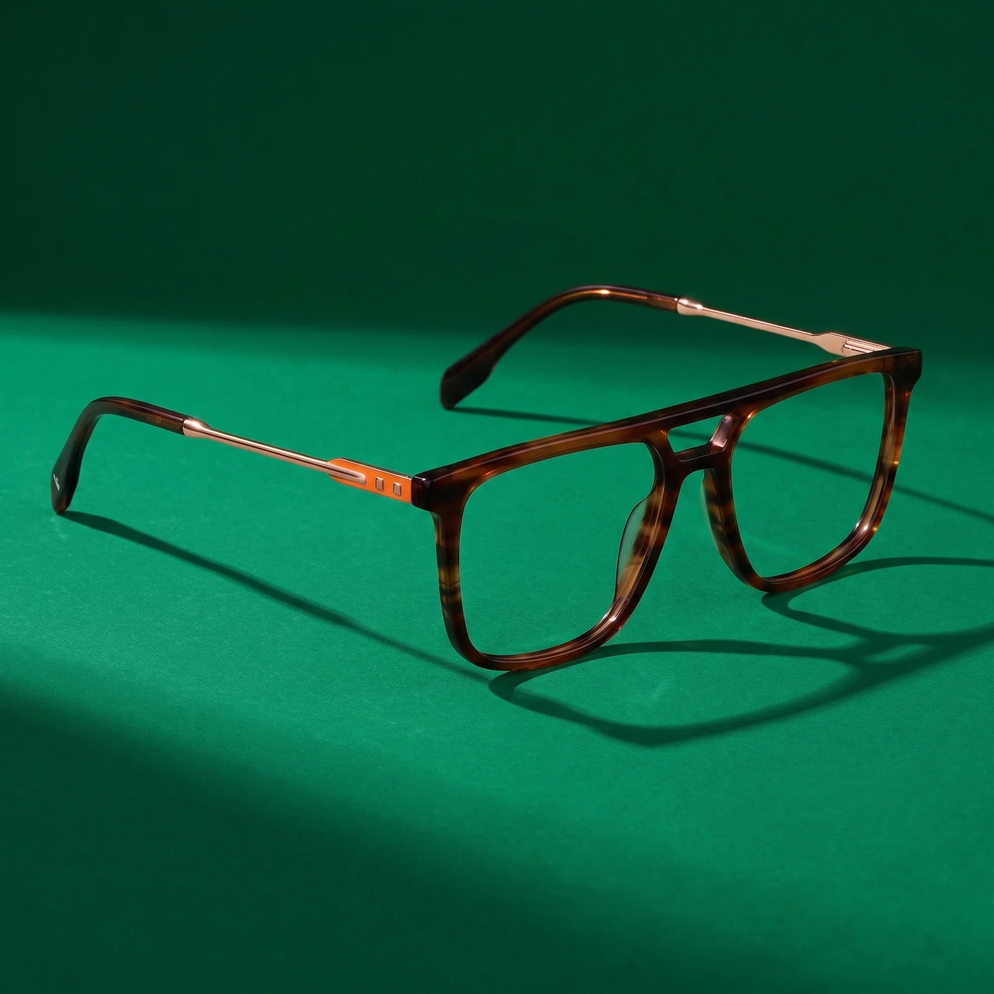 Fiore 10177 eyeglasses in tortoiseshell – editorial still life on a saturated emerald set