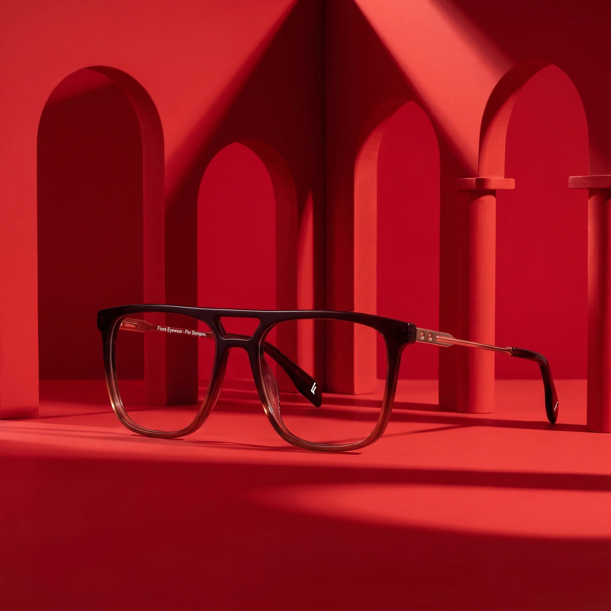 Fiore 10177 eyeglasses in brown – staged on a sculptural vivid red architecture set
