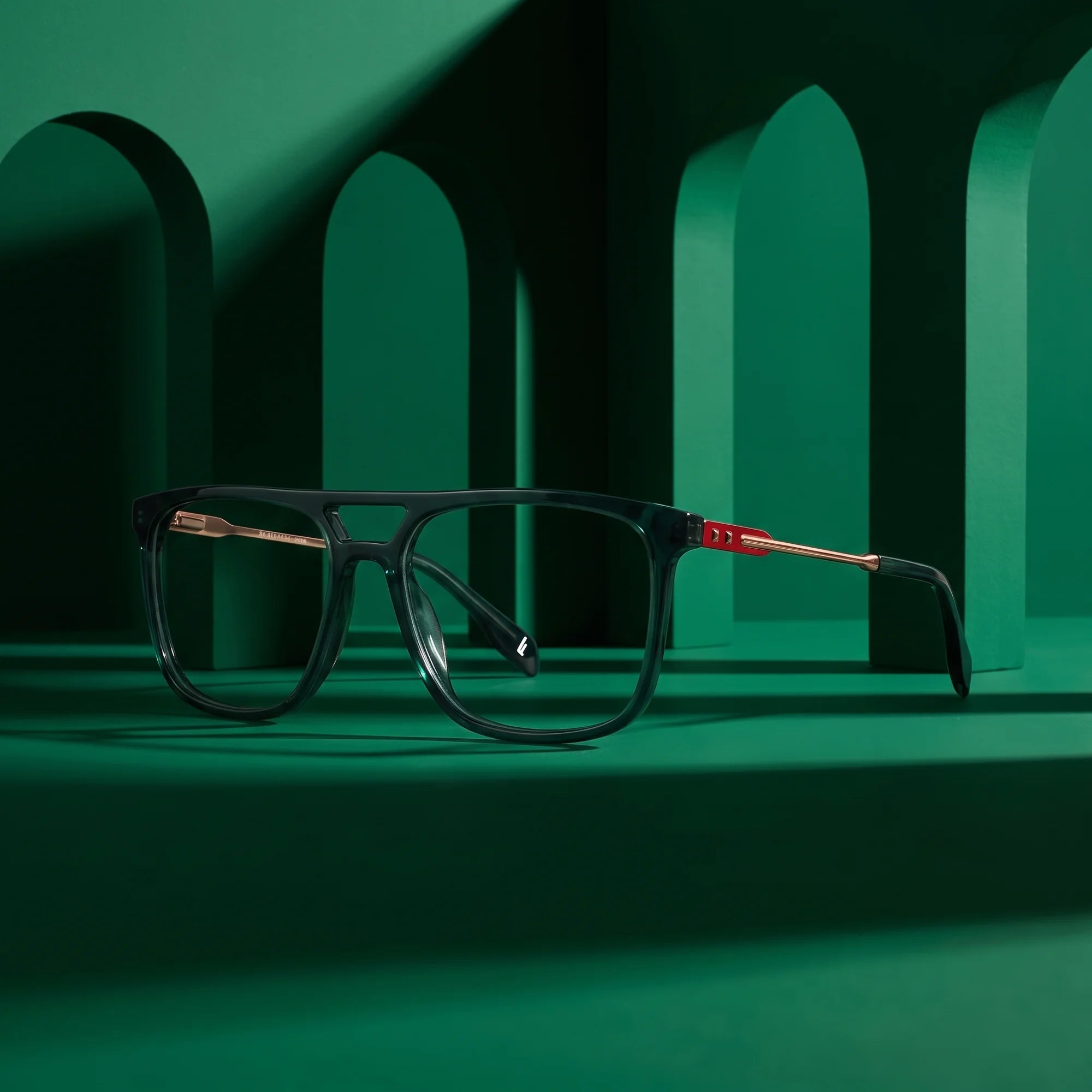 Fiore 10177 eyeglasses in green – staged on a sculptural emerald architecture set