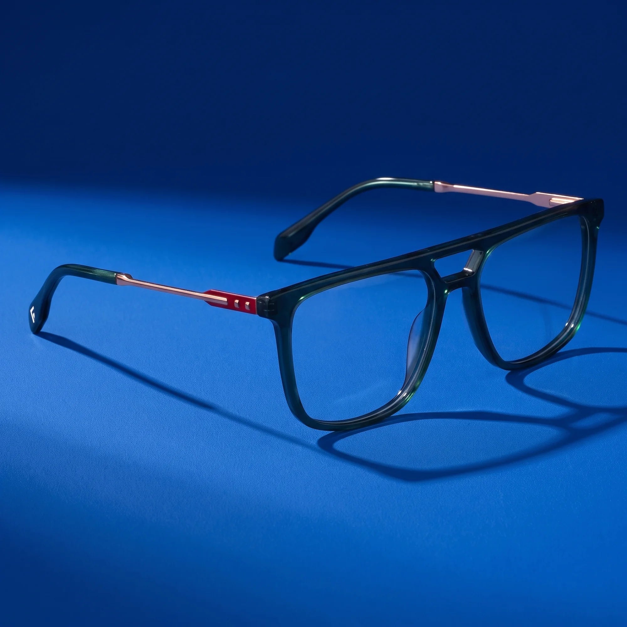 Fiore 10177 eyeglasses in green – editorial still life on a saturated cobalt set