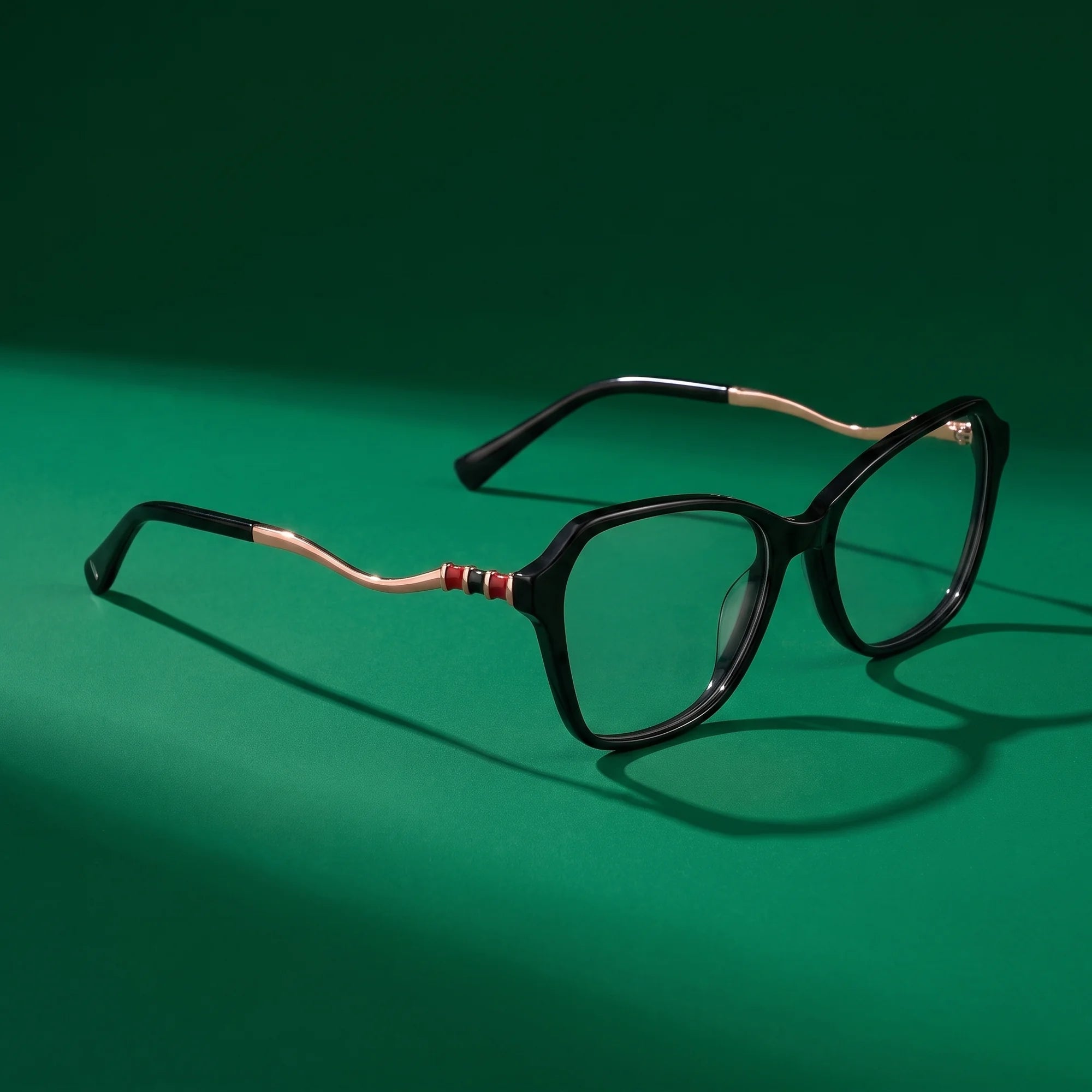 Fiore 1030 eyeglasses in black – editorial still life on a saturated emerald set